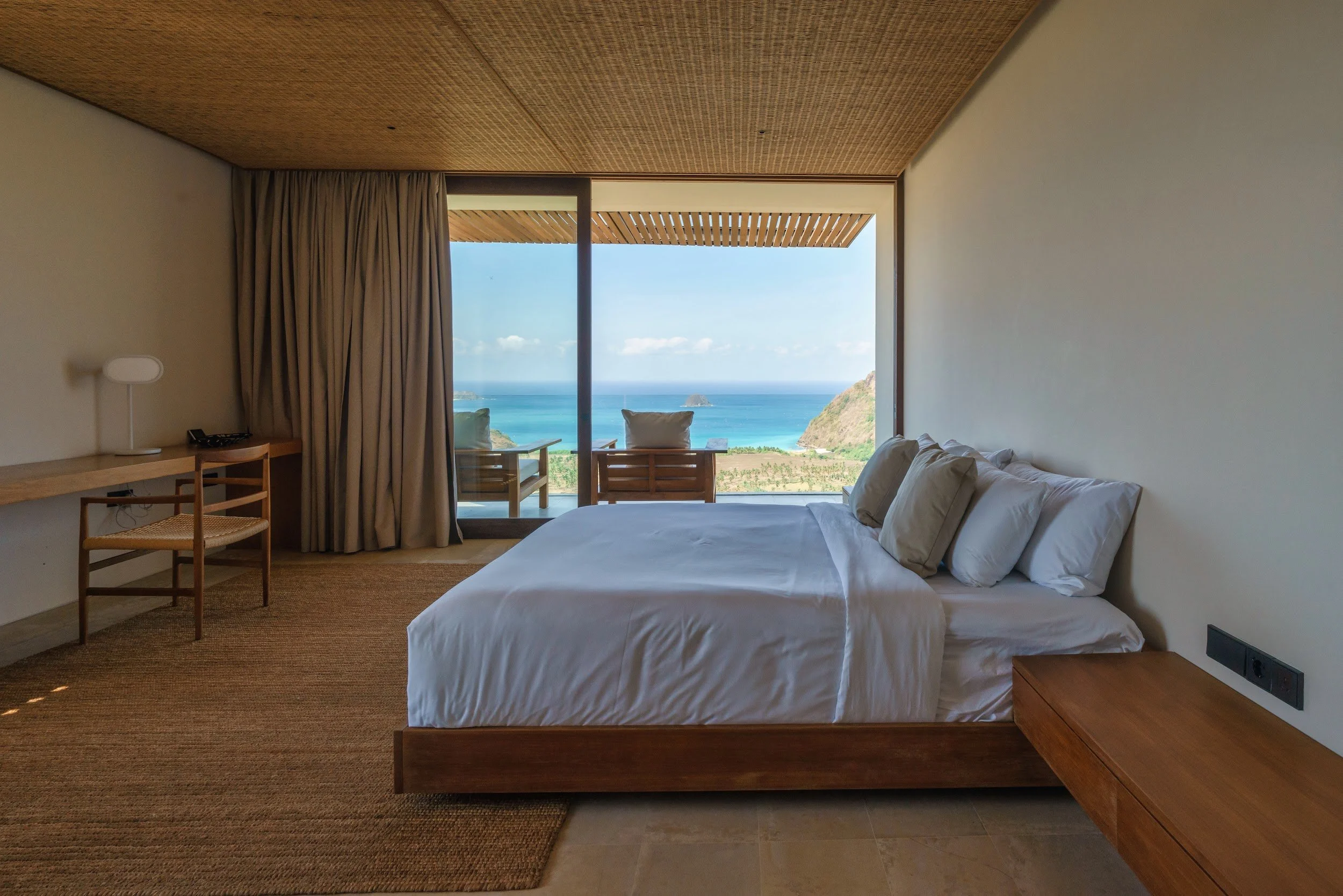King bed facing the ocean in the primary suite at Villa Kai Lani