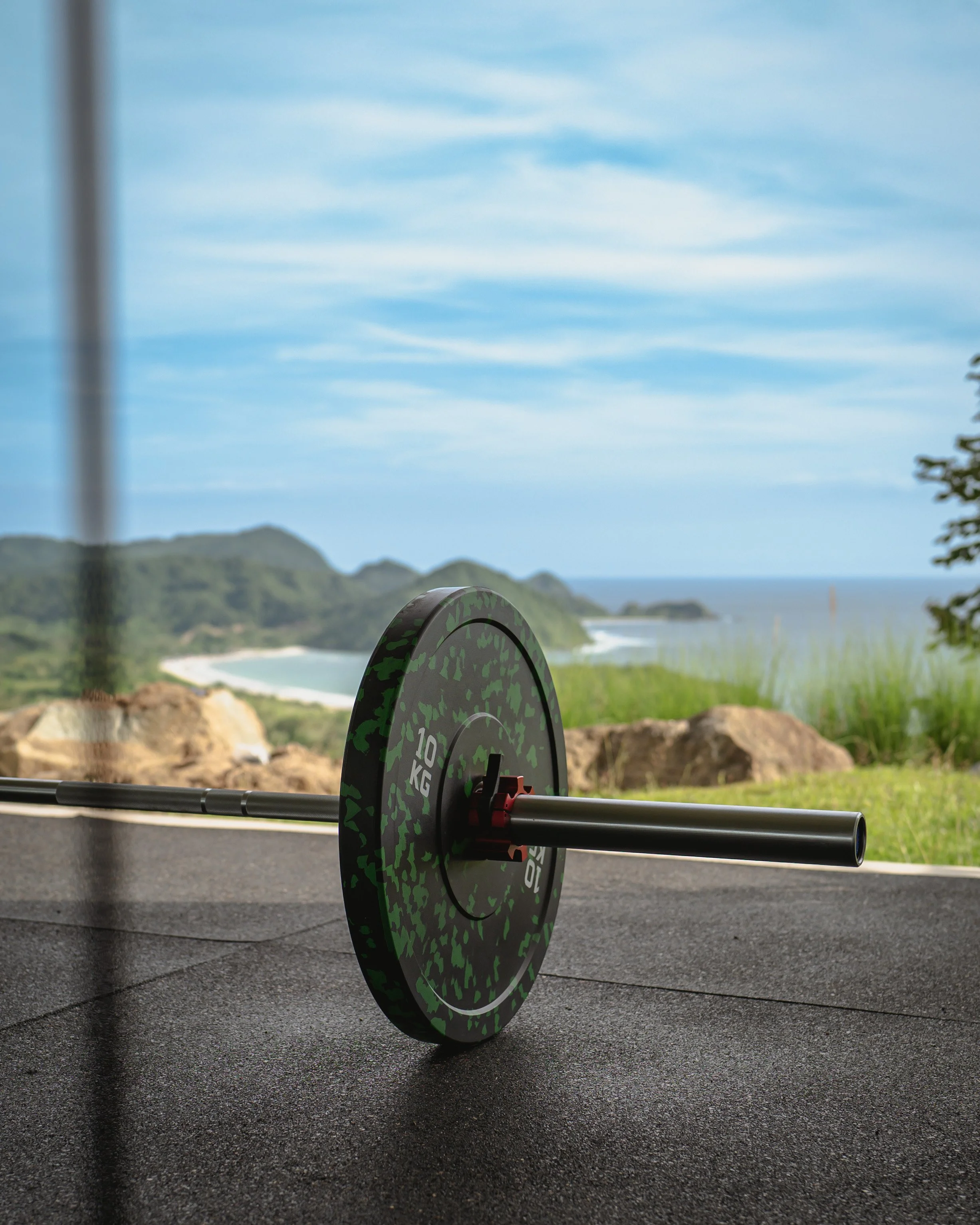 Home gym with weights and an ocean view at Villa Kai Lani