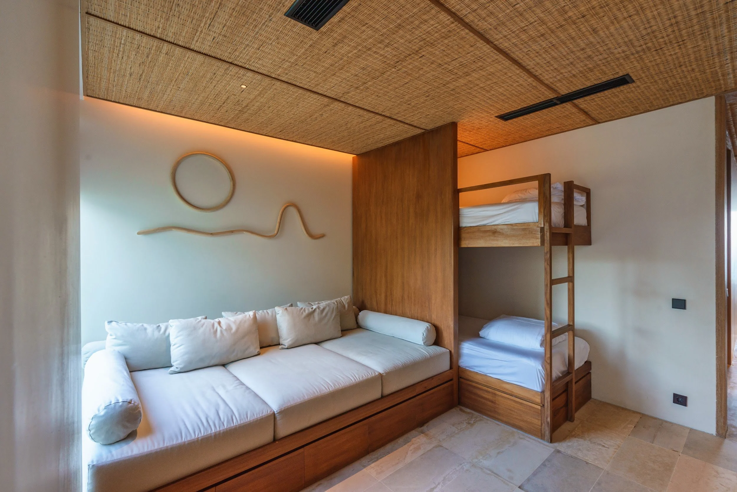 Cushioned daybed beneath the window in the bunk room at Villa Kai Lani