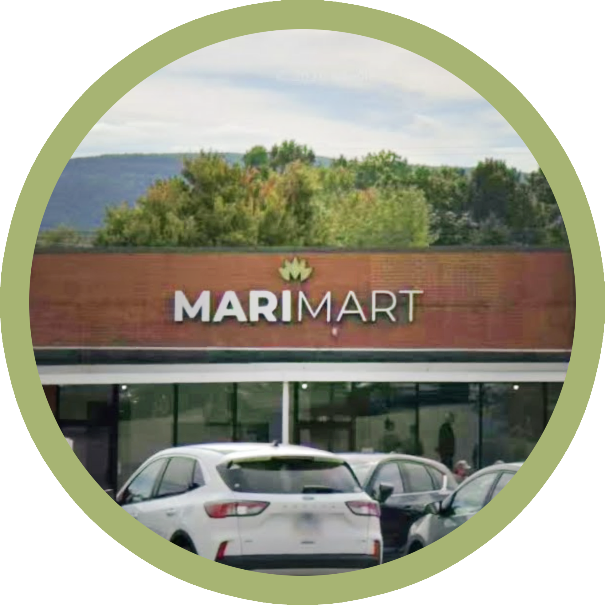 Marimart shopping center storefront with parked cars and trees in the background