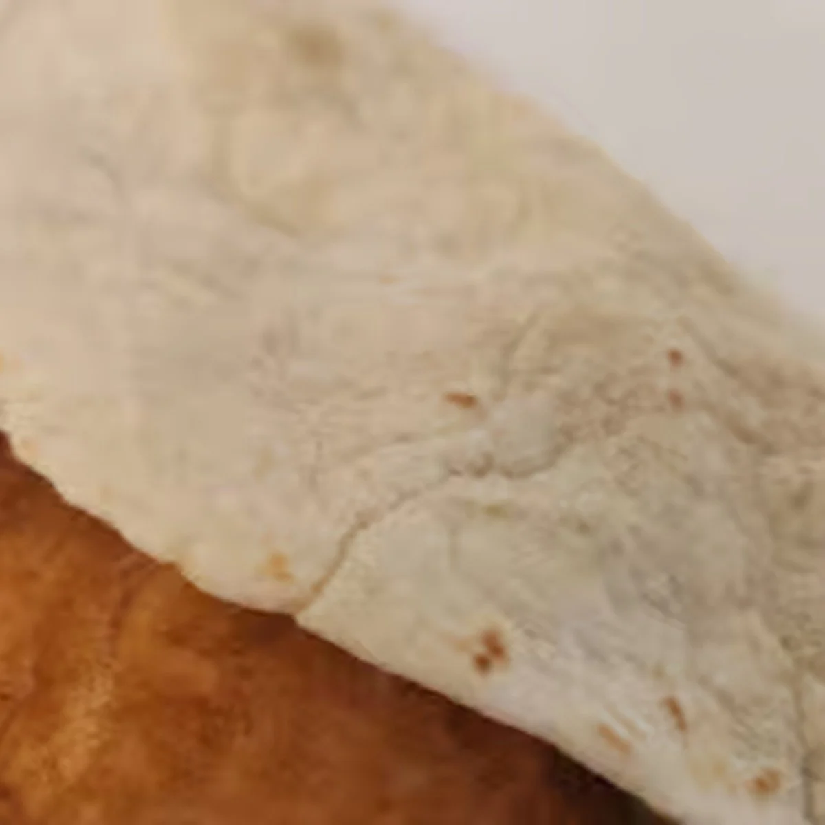 Close-up of a flour tortilla on a wooden surface