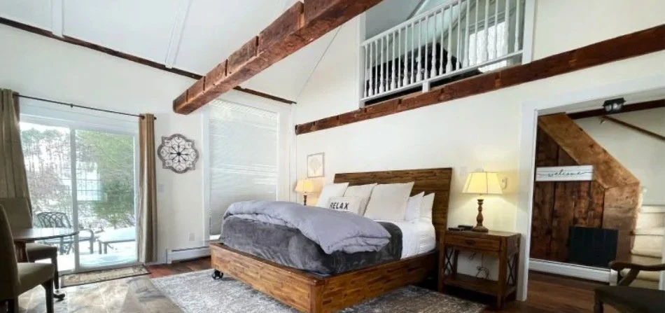 Farm Road accommodation with exposed beams, fireplace, and large windows