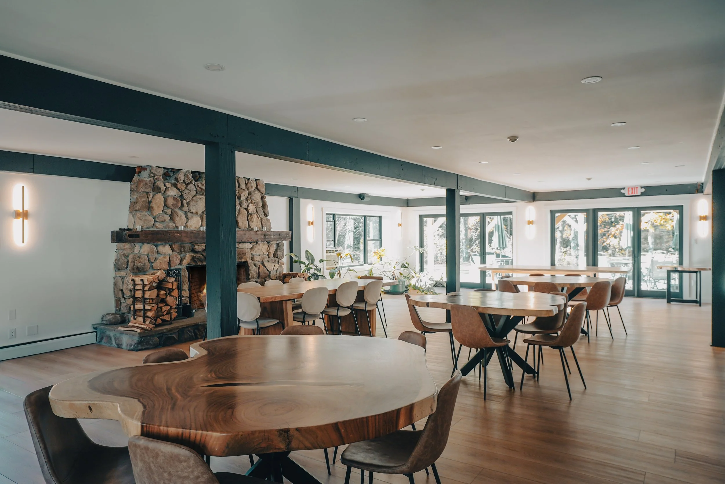 Farm Road great room arranged with meeting tables and large windows