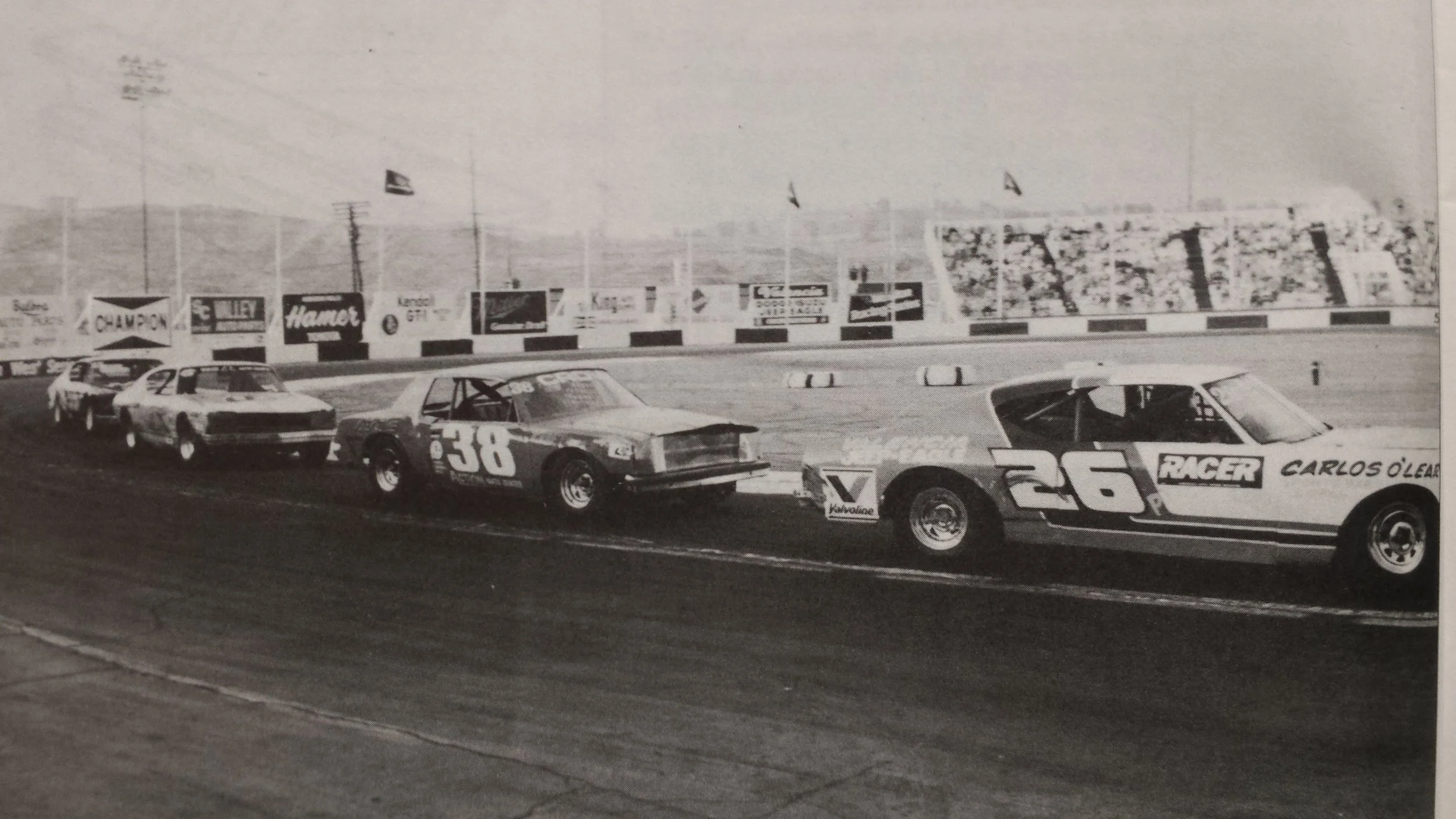 Car 26 Greg Benner leads number 38 through the corner in the pro stock division at saugus speedway.