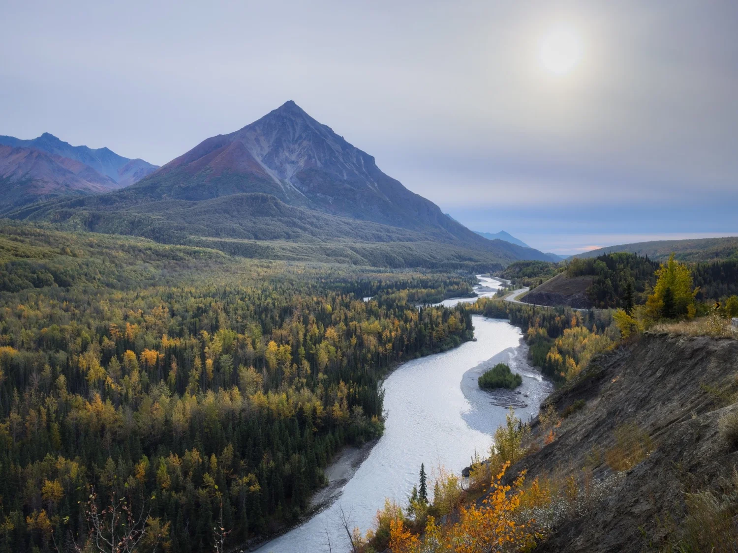 Winding river beneath a mountain in Alaska