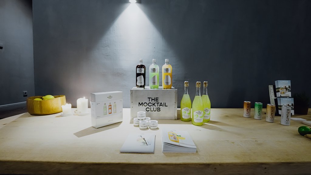 The Mocktail Club bottles on a spotlit table