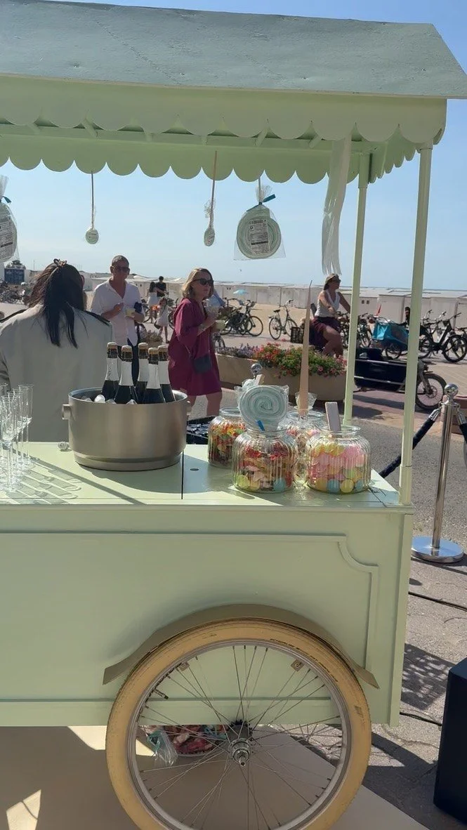 A mint candy cart with champagne and sweet jars on the Zoute seafront