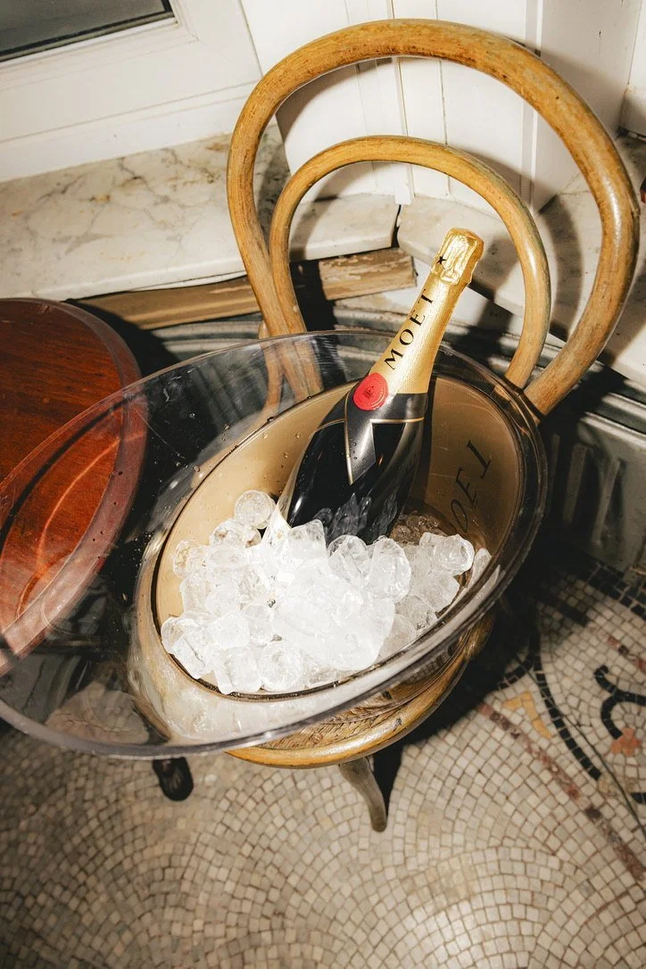 A bottle of Moët on ice on a bentwood chair