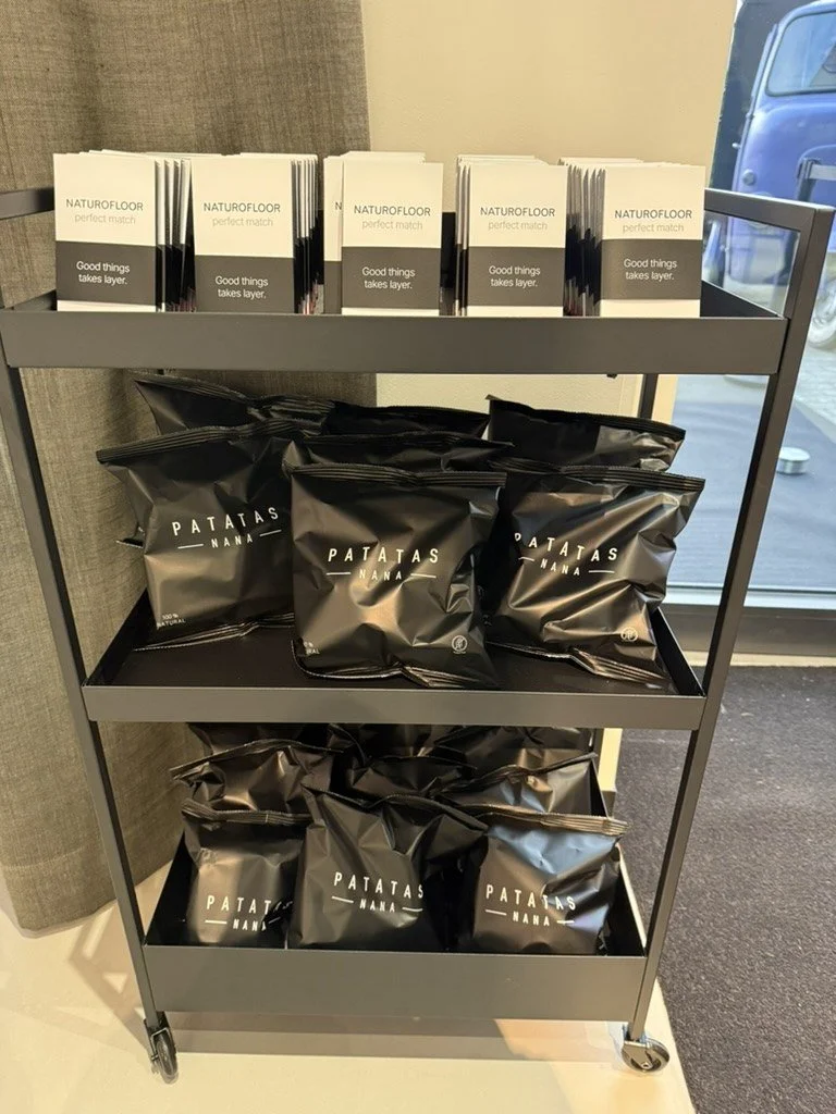 A cart with Naturofloor booklets and branded crisps