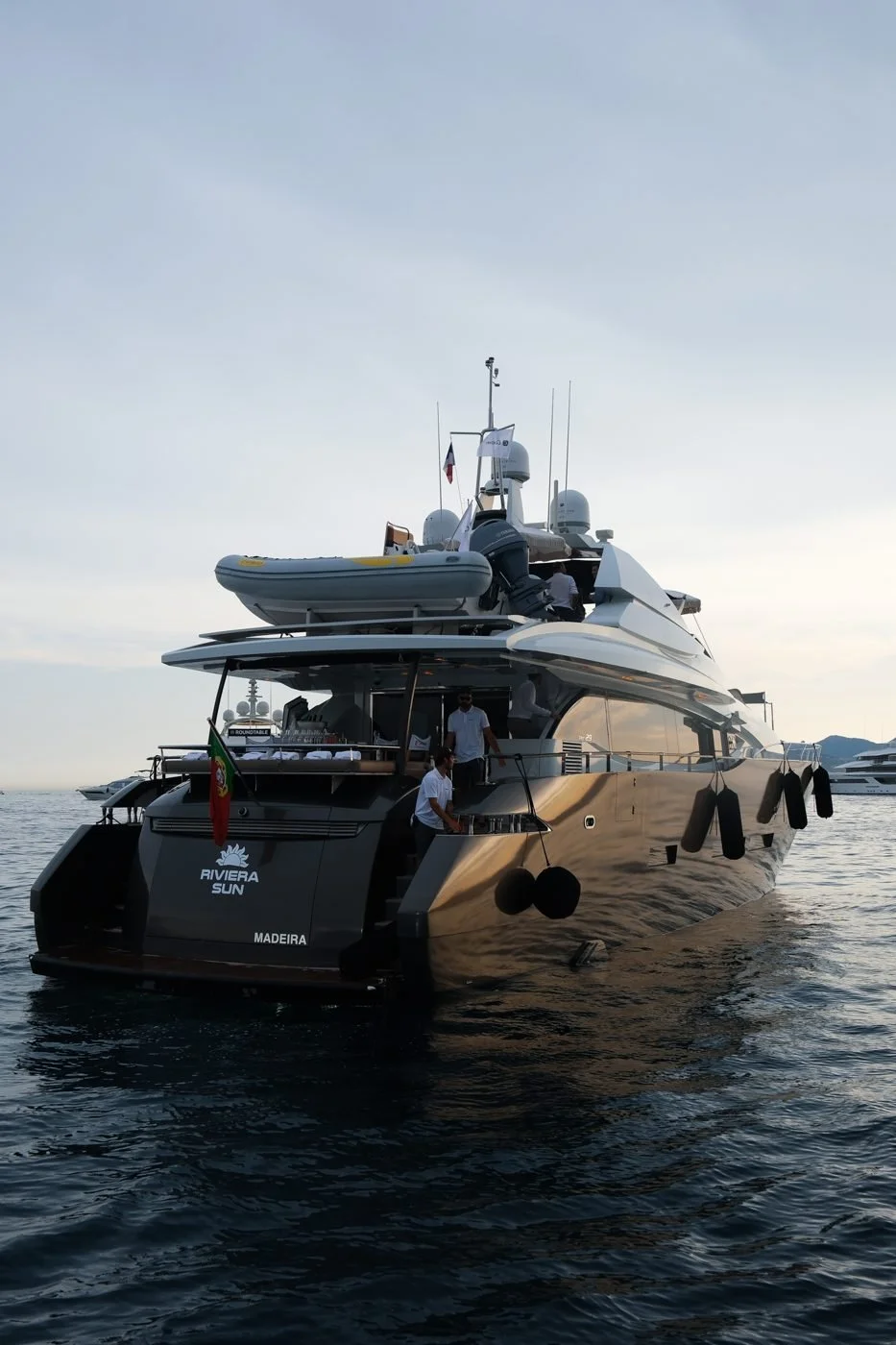 A large yacht on the water at dusk off the coast of Cannes