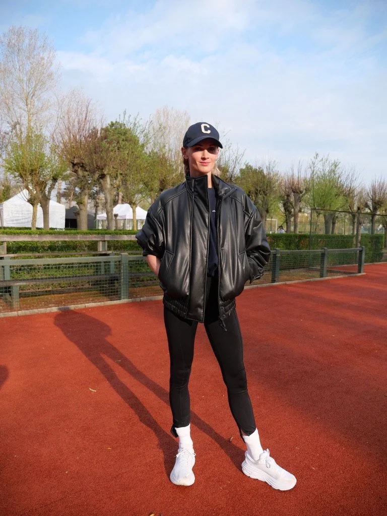A guest in a leather jacket and cap on the track
