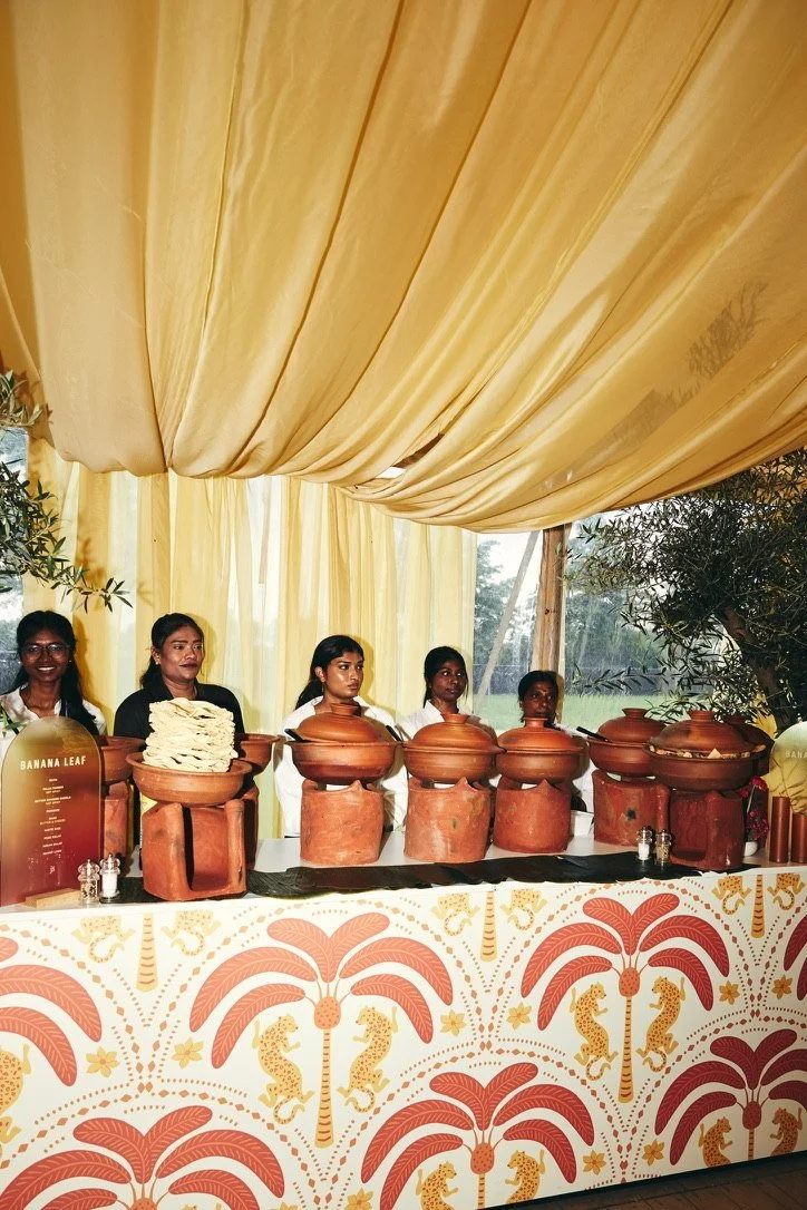 A buffet of terracotta pots under yellow drapes