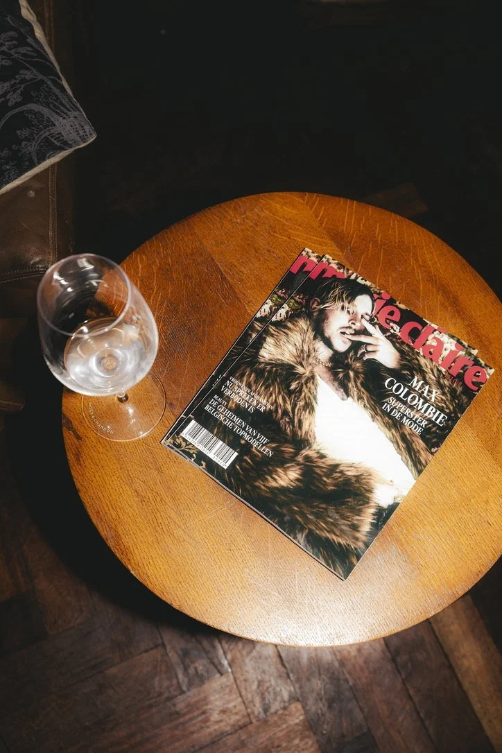 The Marie Claire cover with Max Colombie on a wooden side table