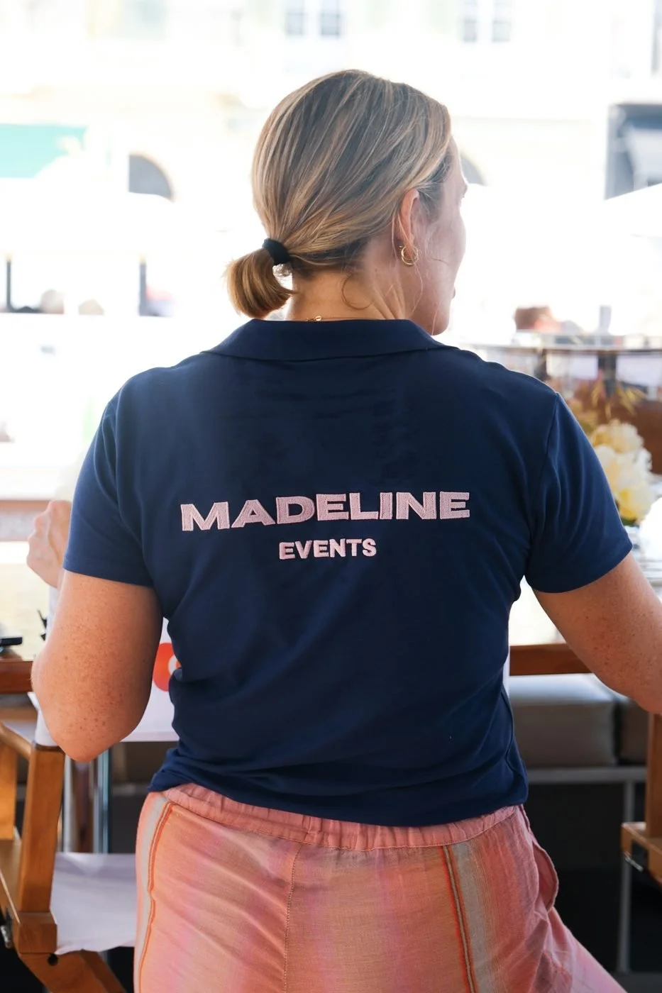 A Madeline team member on deck in a Madeline Events shirt