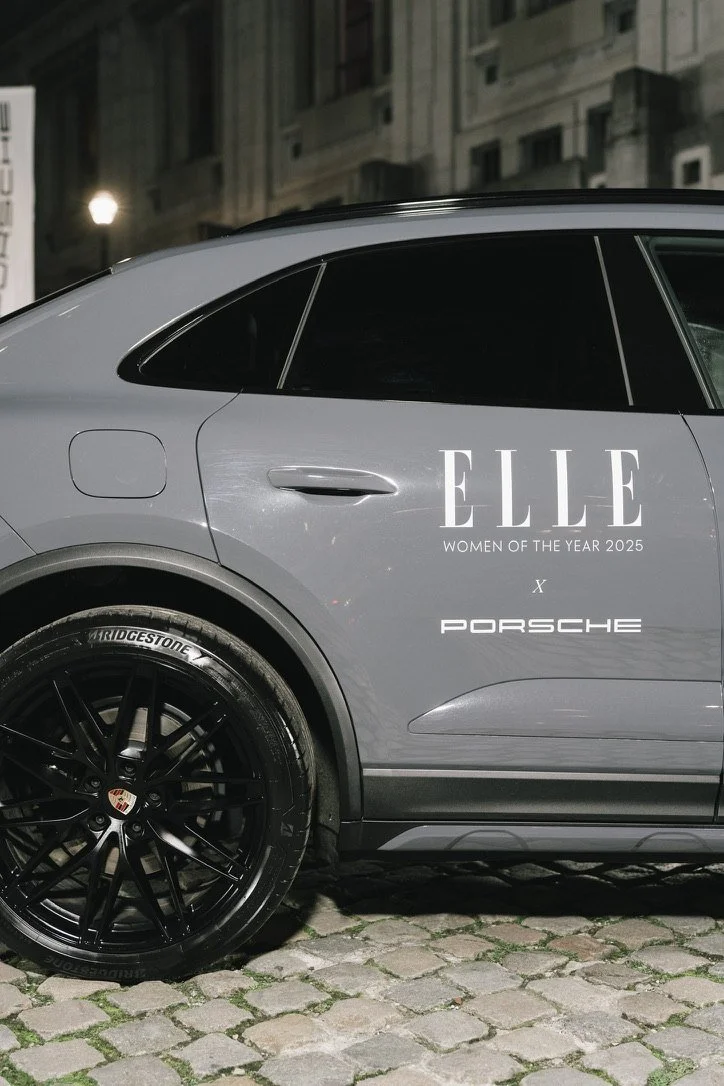 A Porsche branded for ELLE Women of the Year 2025 on cobblestones