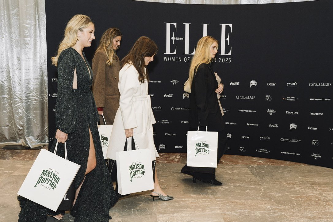 Guests leaving the photo wall with Maison Perrier gift bags