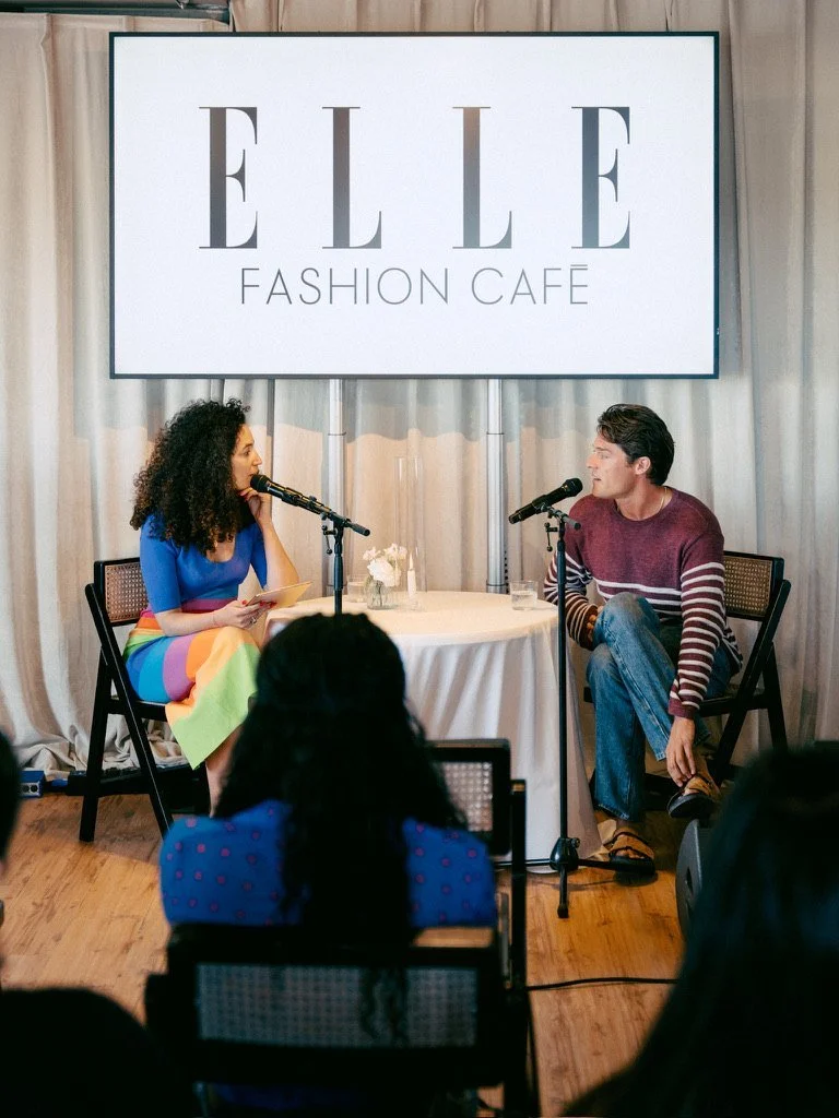 A talk on stage under the ELLE Fashion Café screen