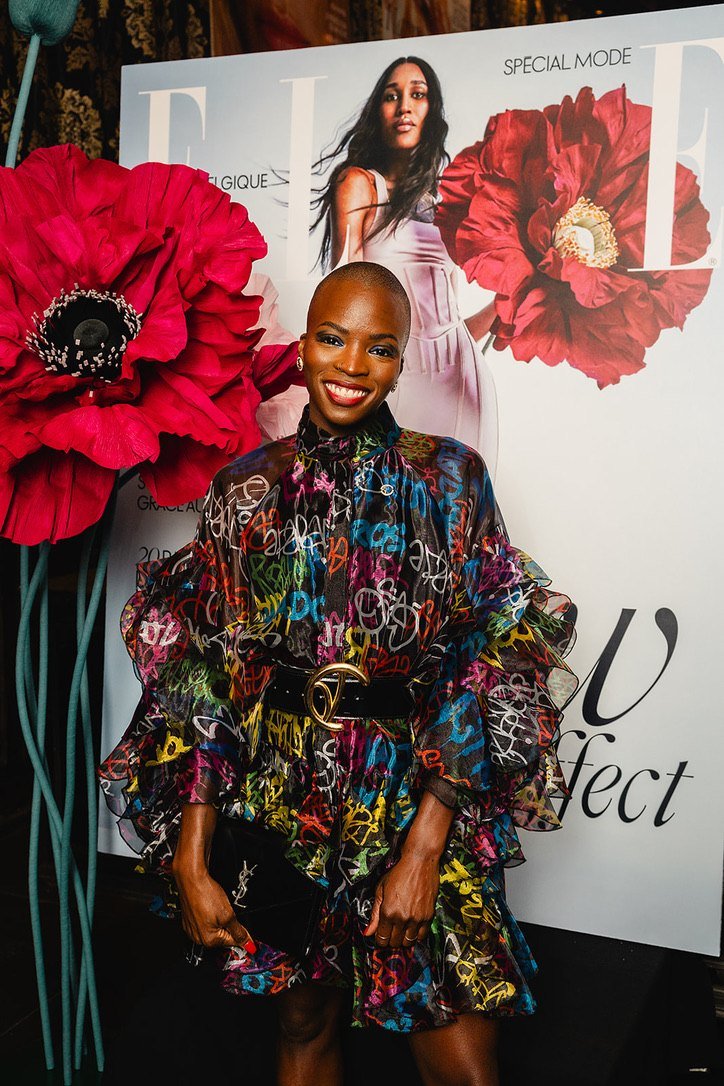 A guest in a colourful graffiti dress at the poppy cover wall