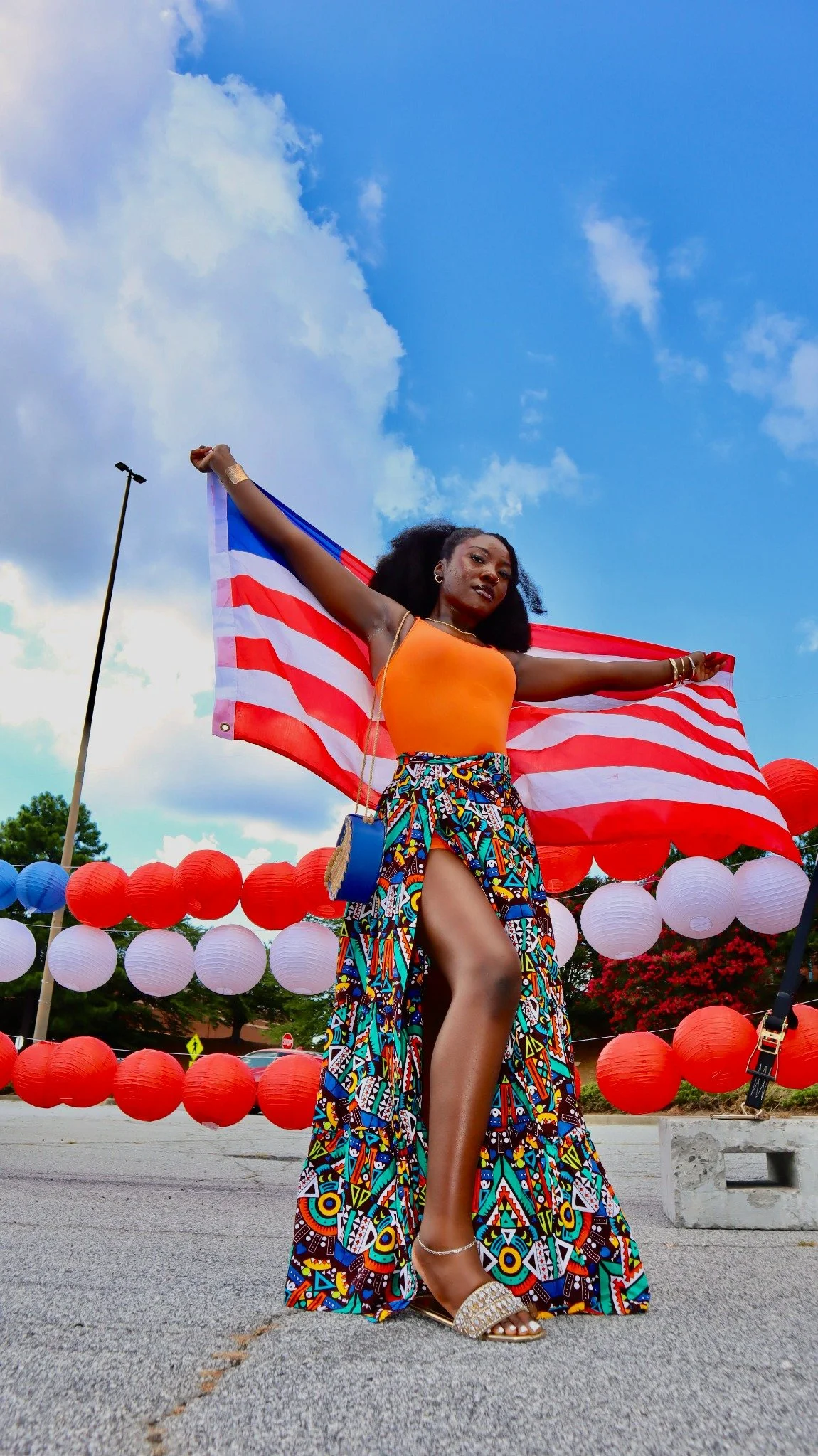 Woman holding the Liberian flag at a Liberian Collective event