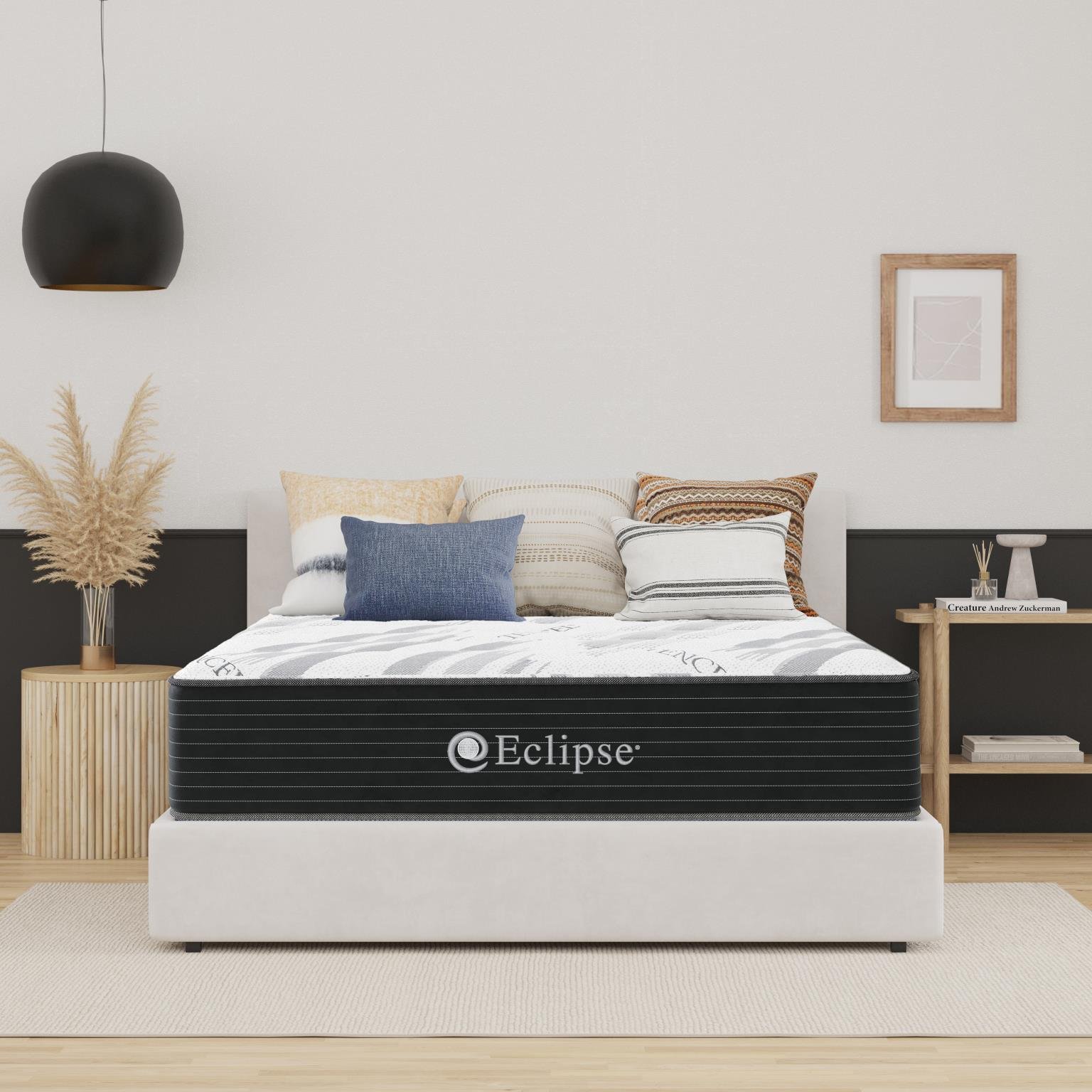BIA Morey Firm mattress with a white quilted top and black border on a light upholstered bed in a bedroom
