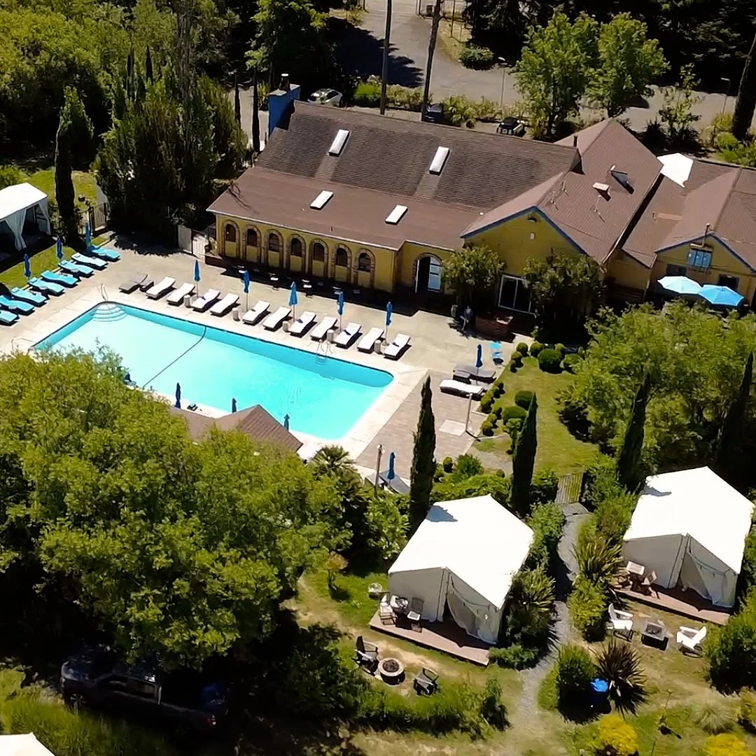 Aerial view of Surrey Resort &mdash; pool, main building and tents