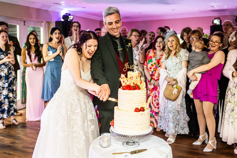 Couple cutting their bespoke wedding cake by My Heavenly Cakes Cambridge