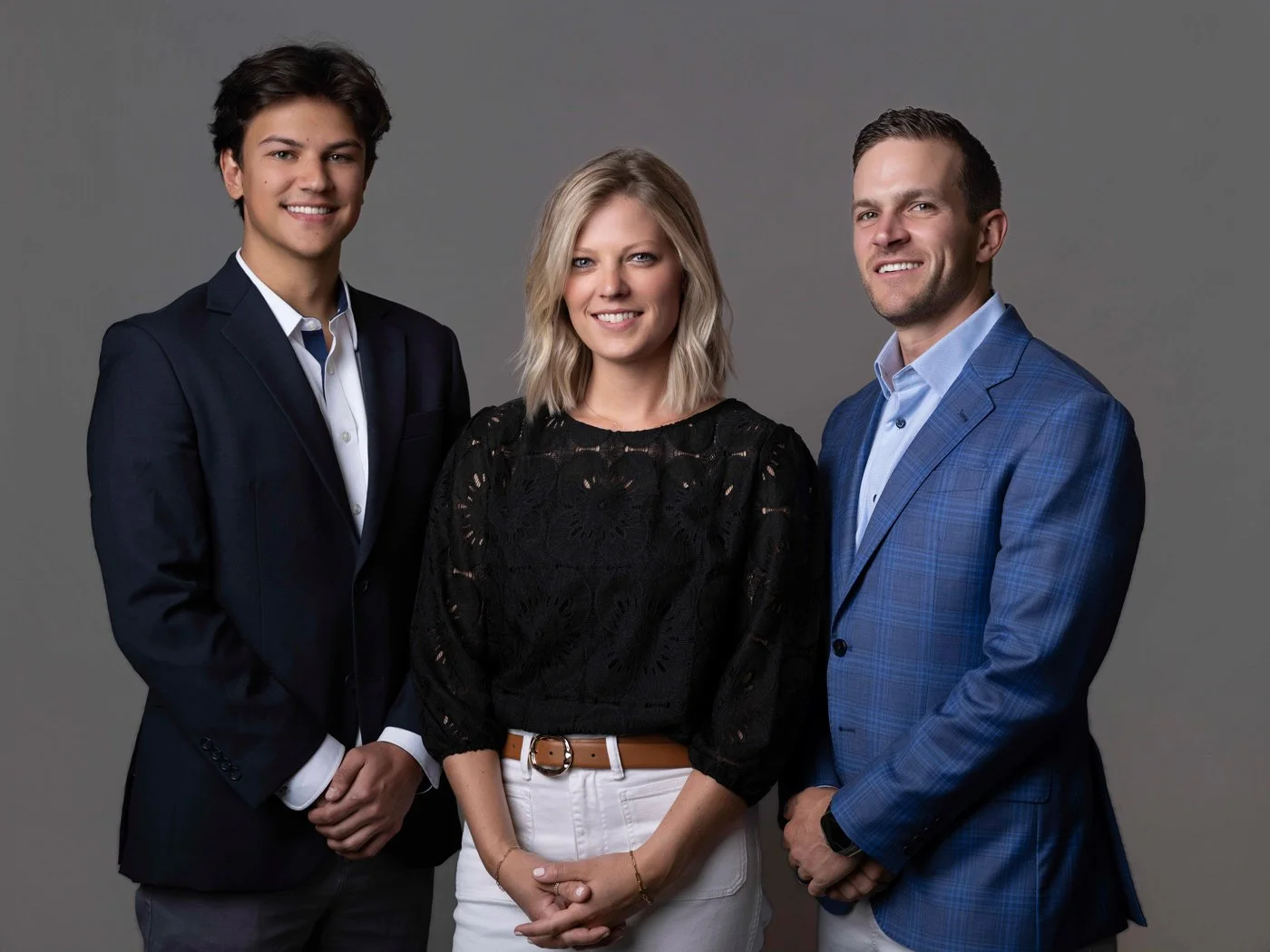 Formal group photograph of the three-person team.