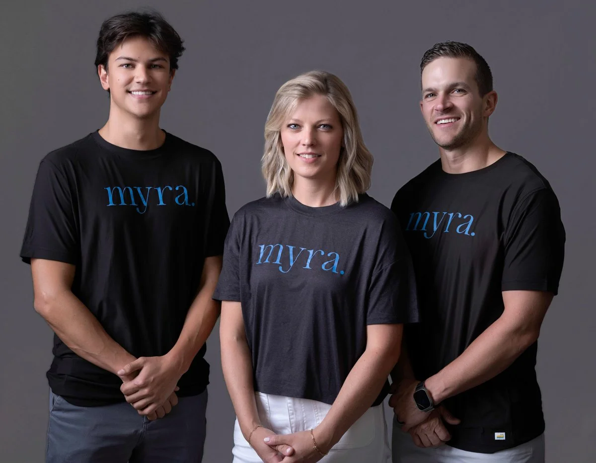 The same three people photographed in company shirts.