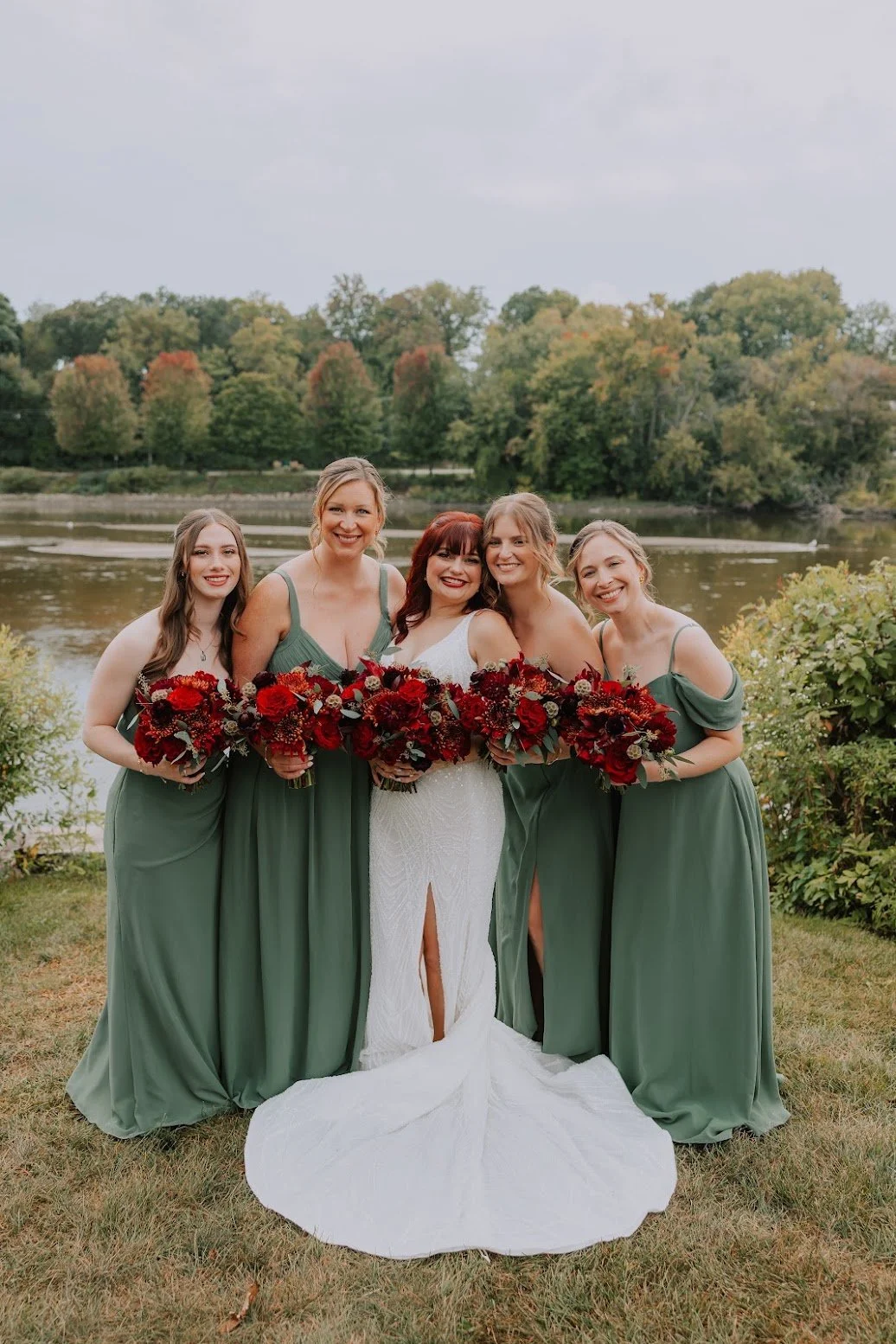 Bride and bridesmaids holding deep red garden-style bouquets, an à la carte order by The Modern Orchid