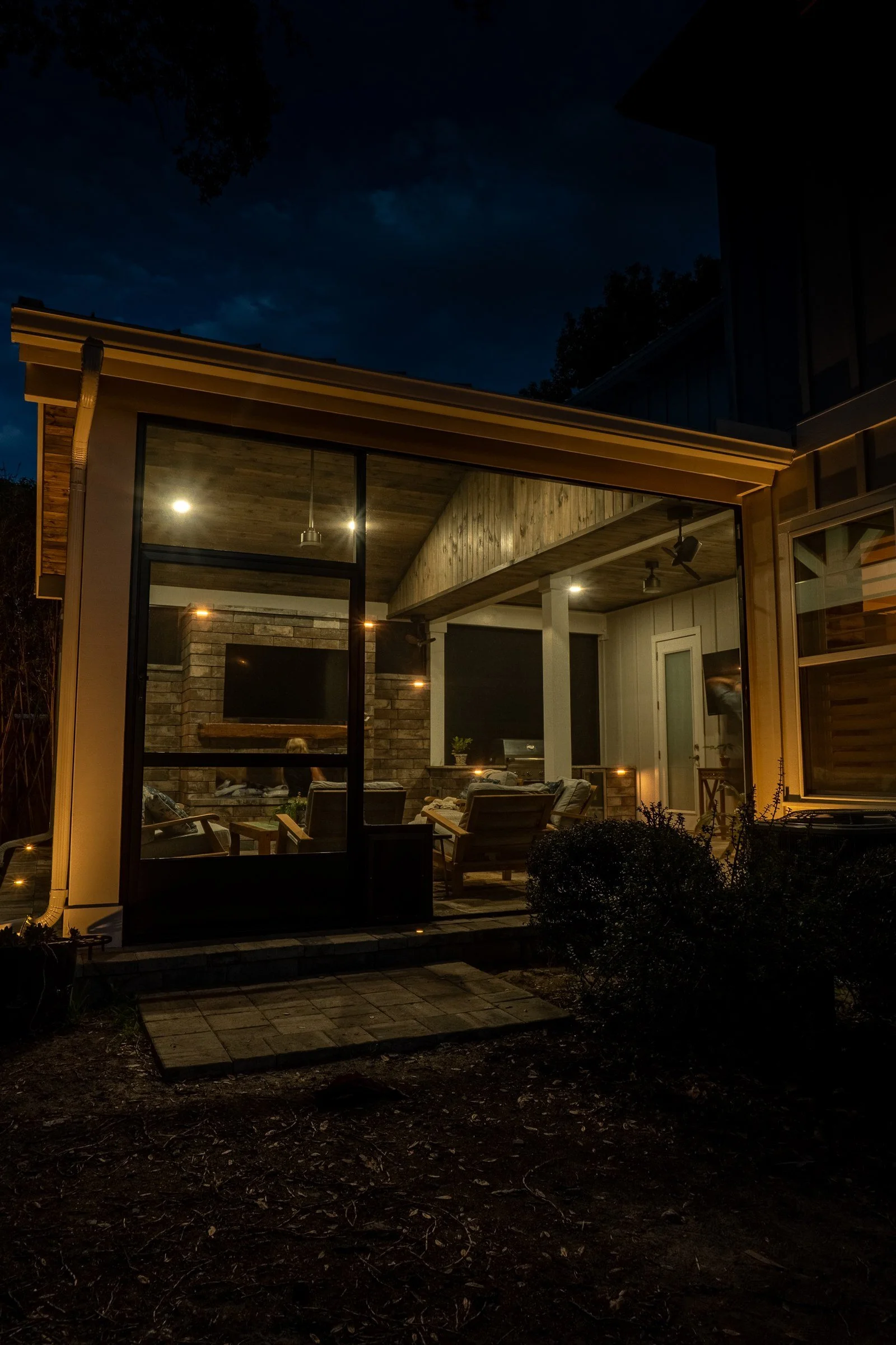 A-frame gazebo inside a screen enclosure at night in Jacksonville Beach