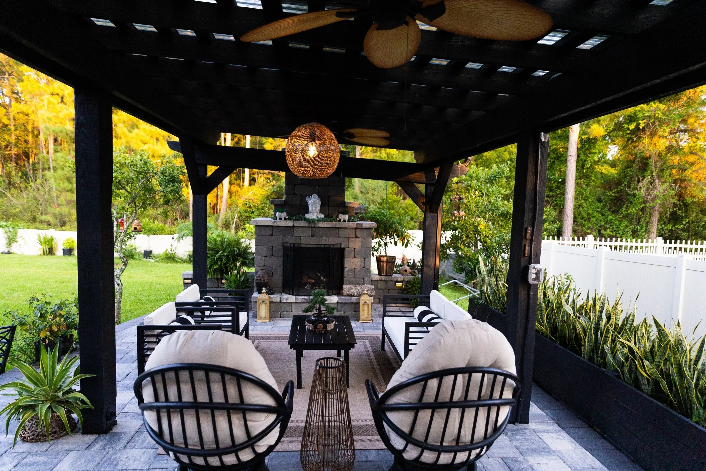 Stone wood-burning fireplace under a cypress pergola in Eagle Landing, Orange Park