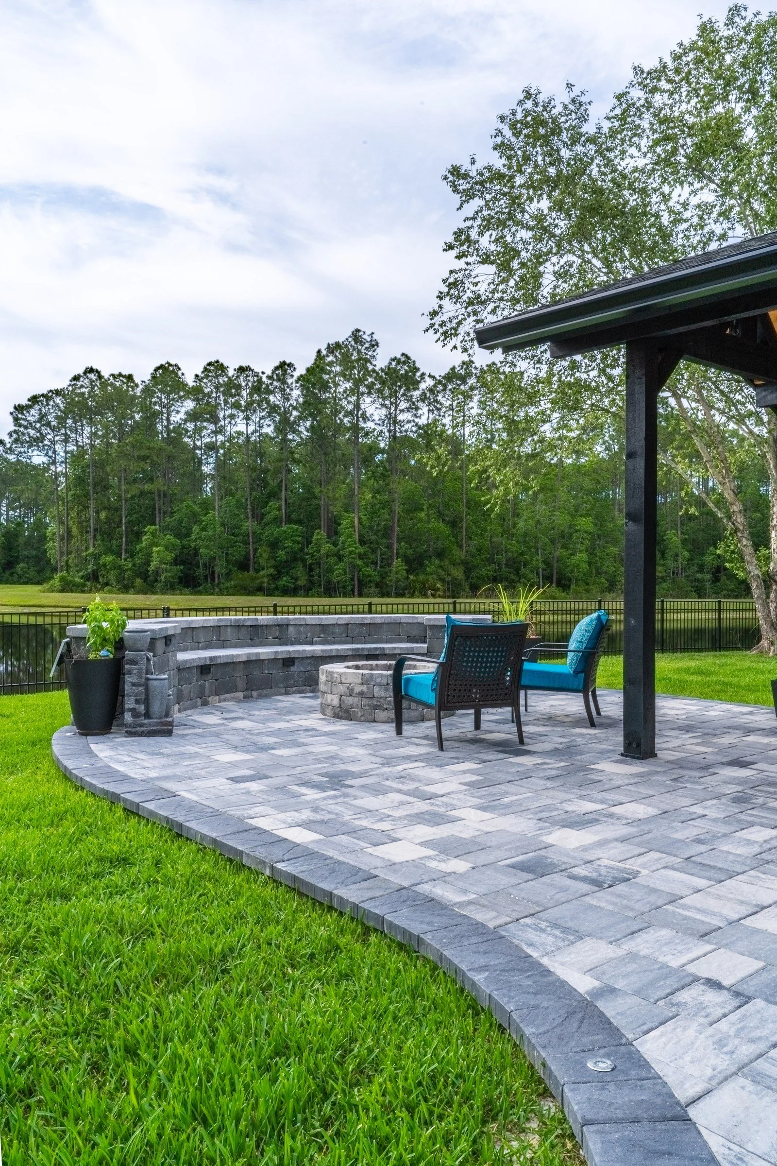 Paver patio with a bench and fire pit in Durbin Crossing, St. Johns