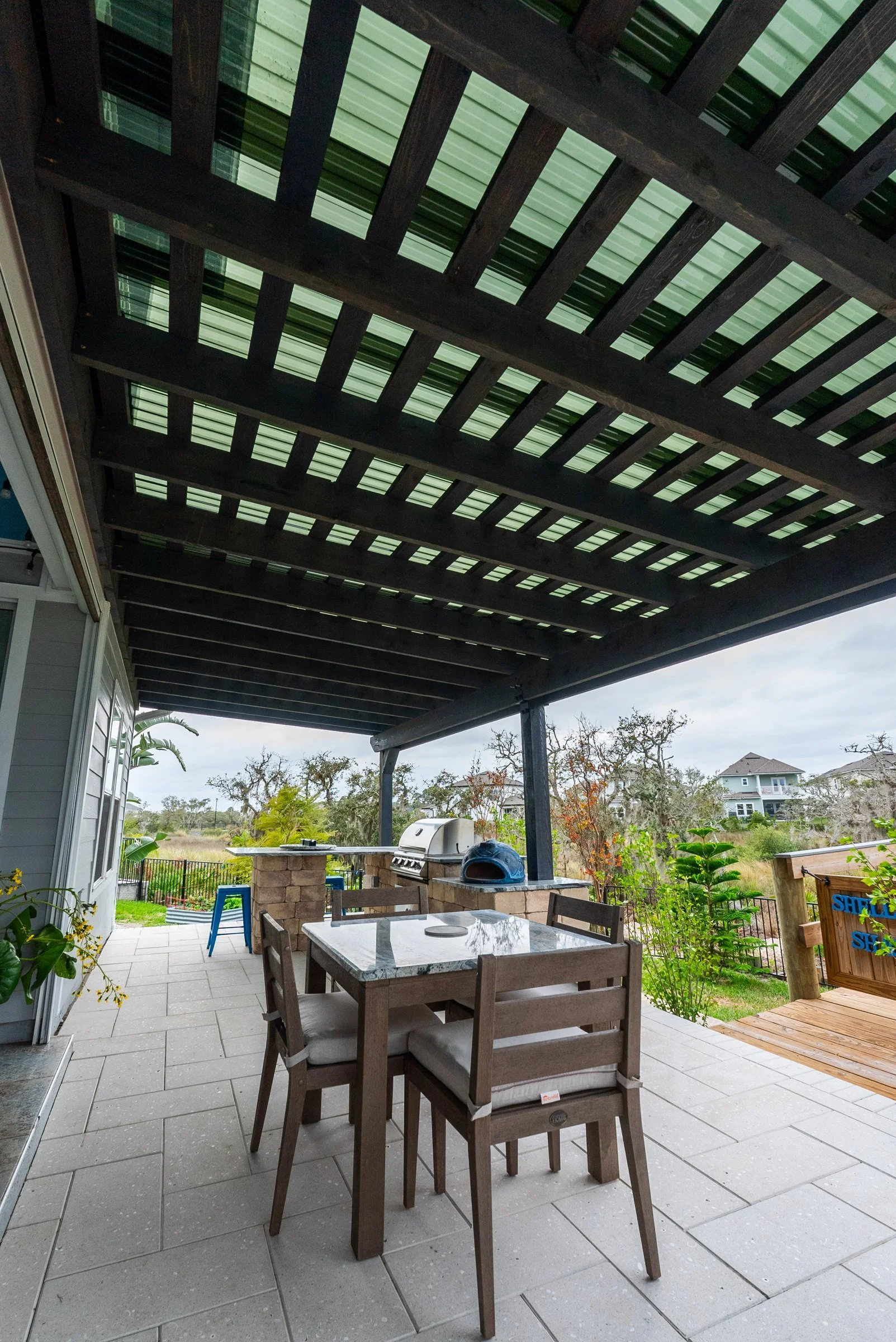 Cedar pergola over a paver patio dining area in St. Augustine
