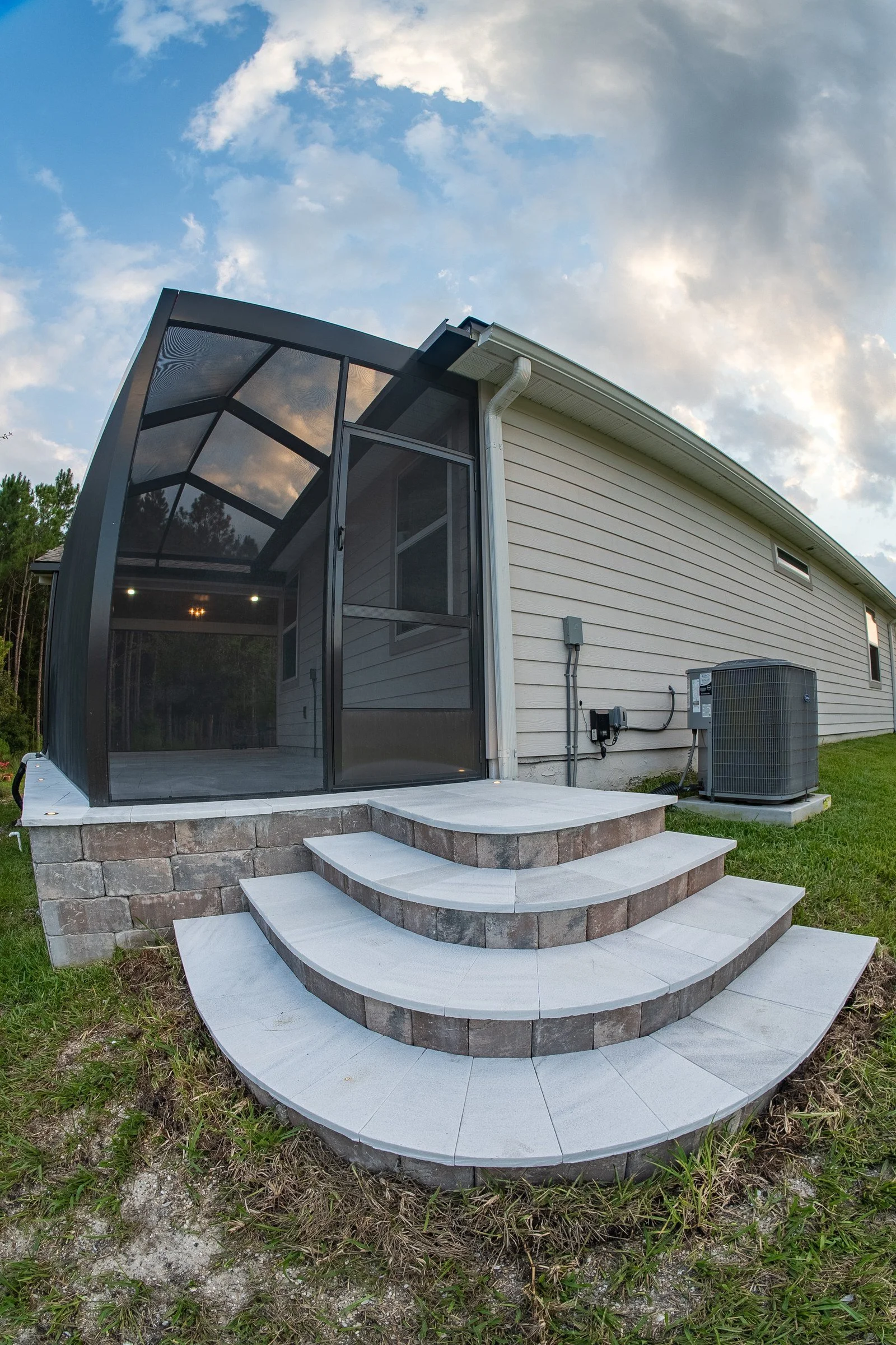 Screen enclosure with curved stone steps in SilverLeaf, St. Augustine