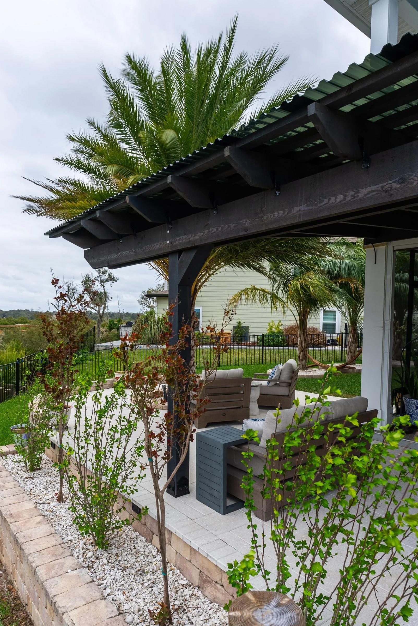 Cedar pergola beside a raised planter wall in St. Augustine