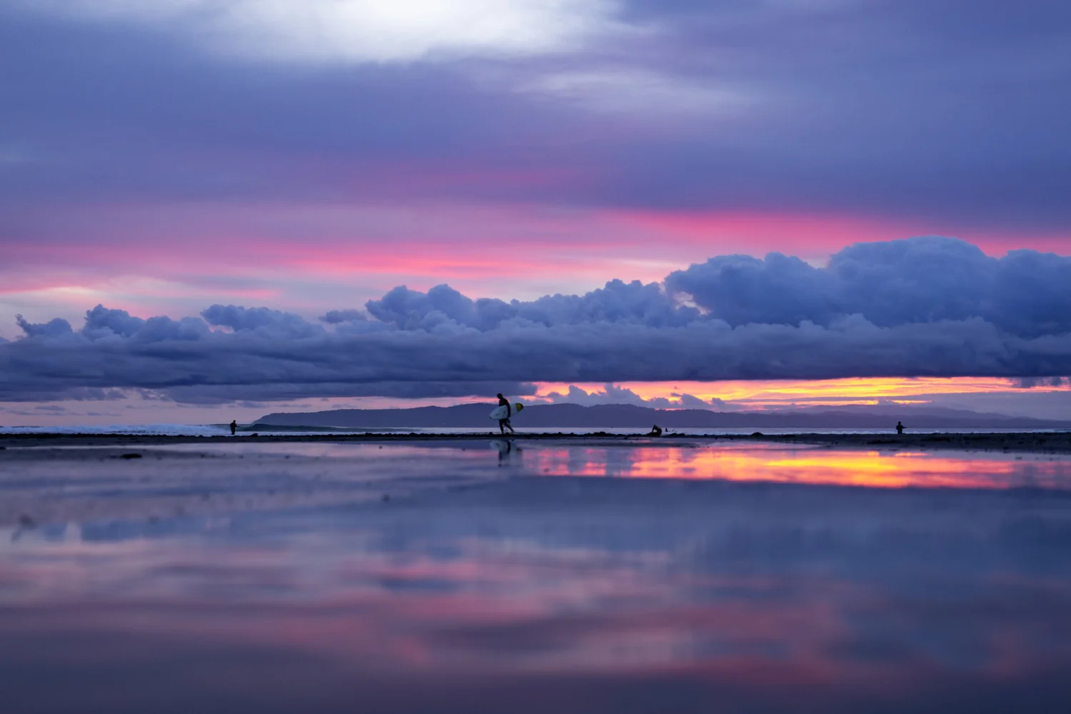 Quiet Pacific water beneath colorful evening light