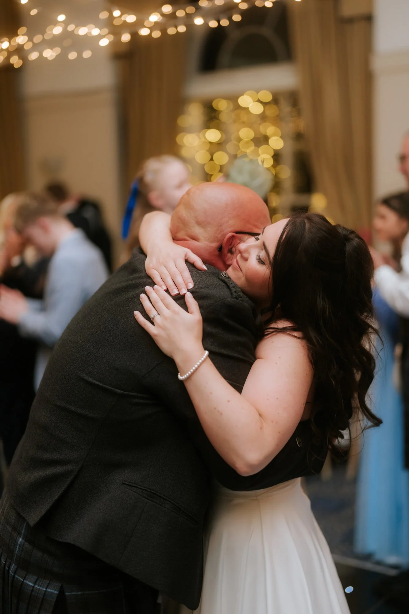 Steph sharing a hug with her dad on the dance floor.