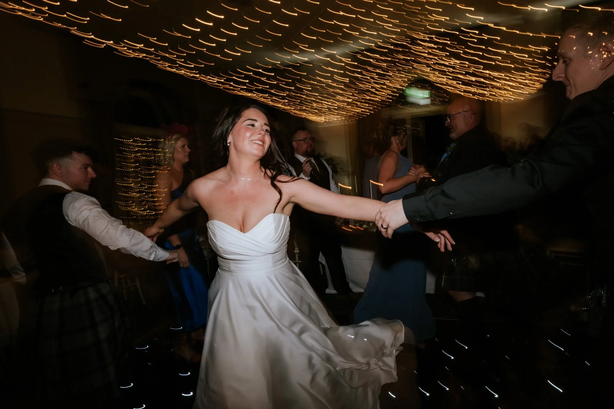 The newlyweds dancing together during the evening reception.
