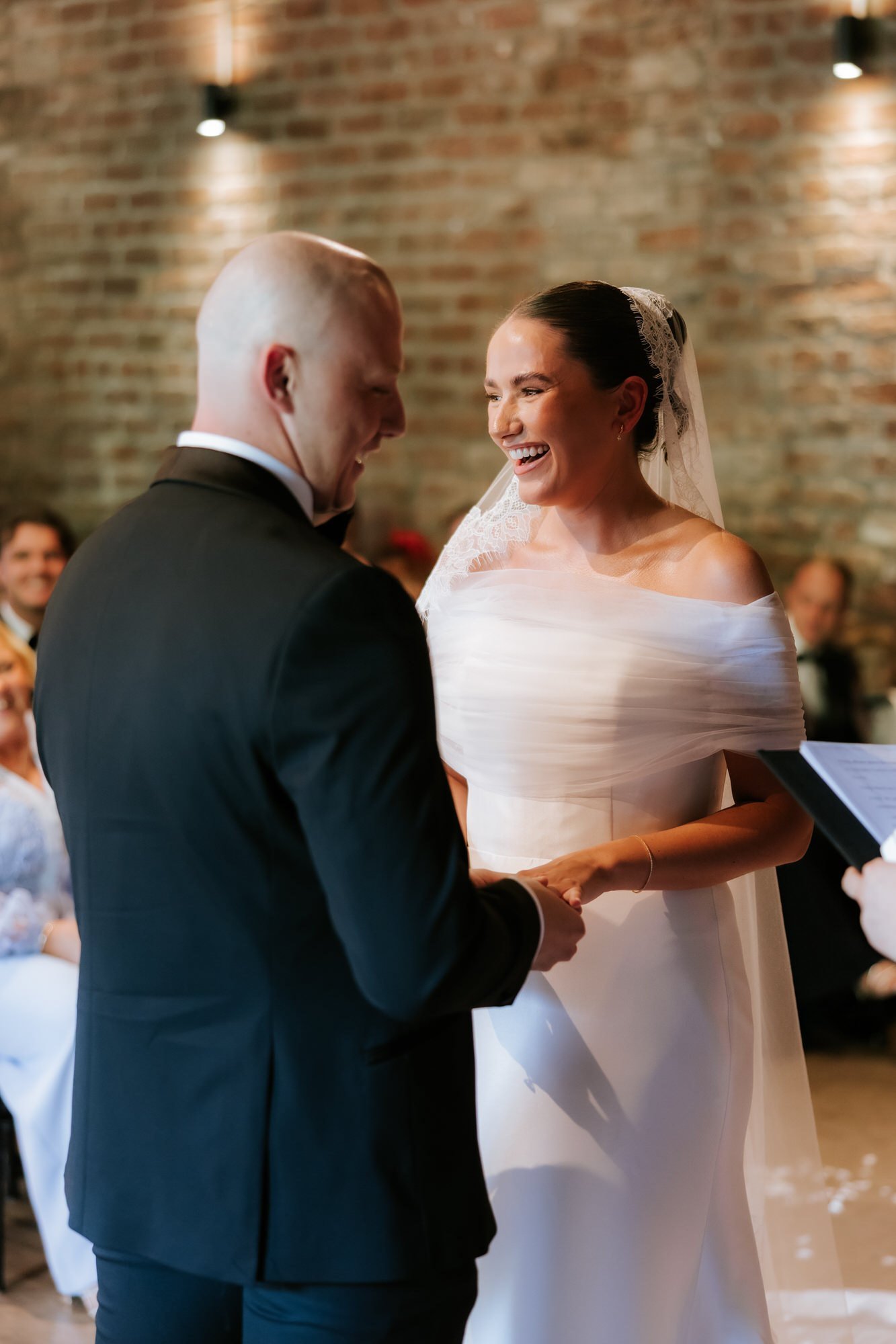 Caitlin and Craig laughing together during the ceremony.