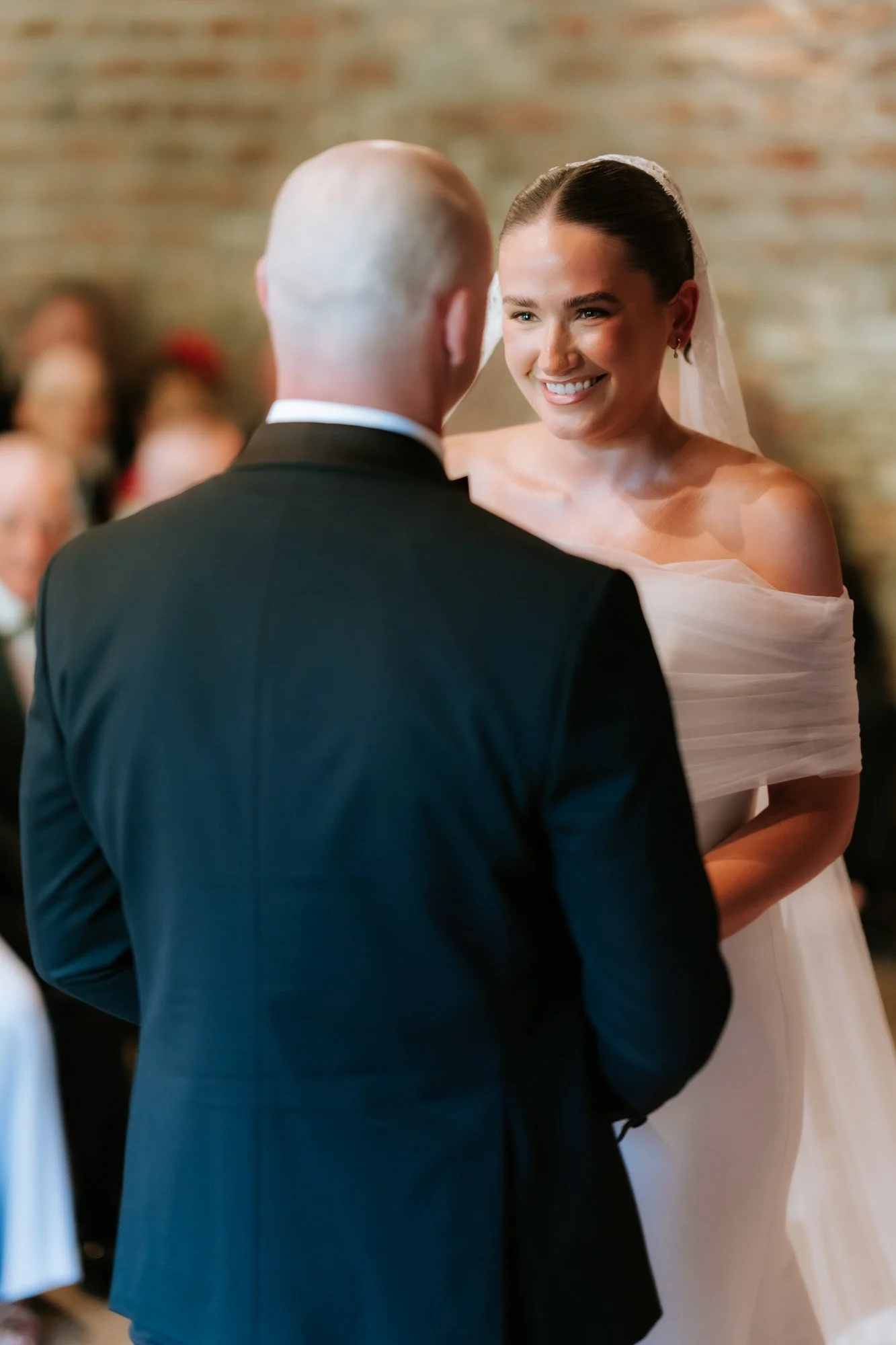 Caitlin looking towards Craig during their wedding vows.