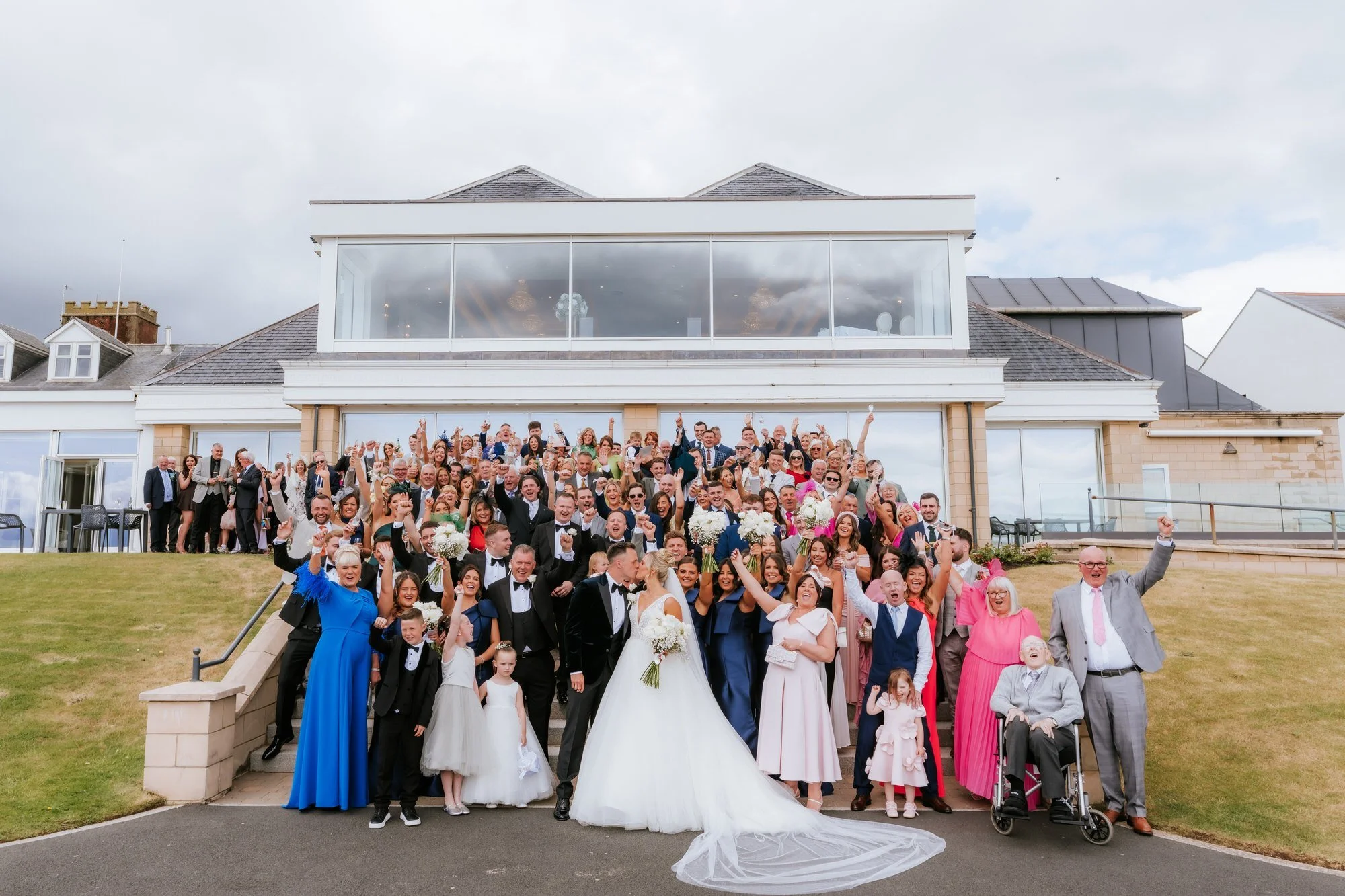 Nicole and Lawrence with their guests gathered on the hotel steps.