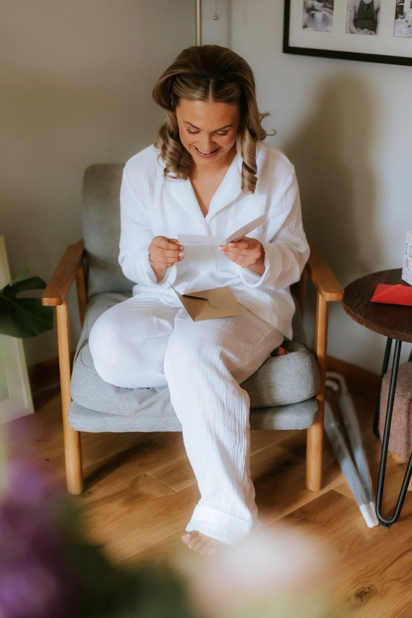 Rhona reading a card during her wedding morning preparations.