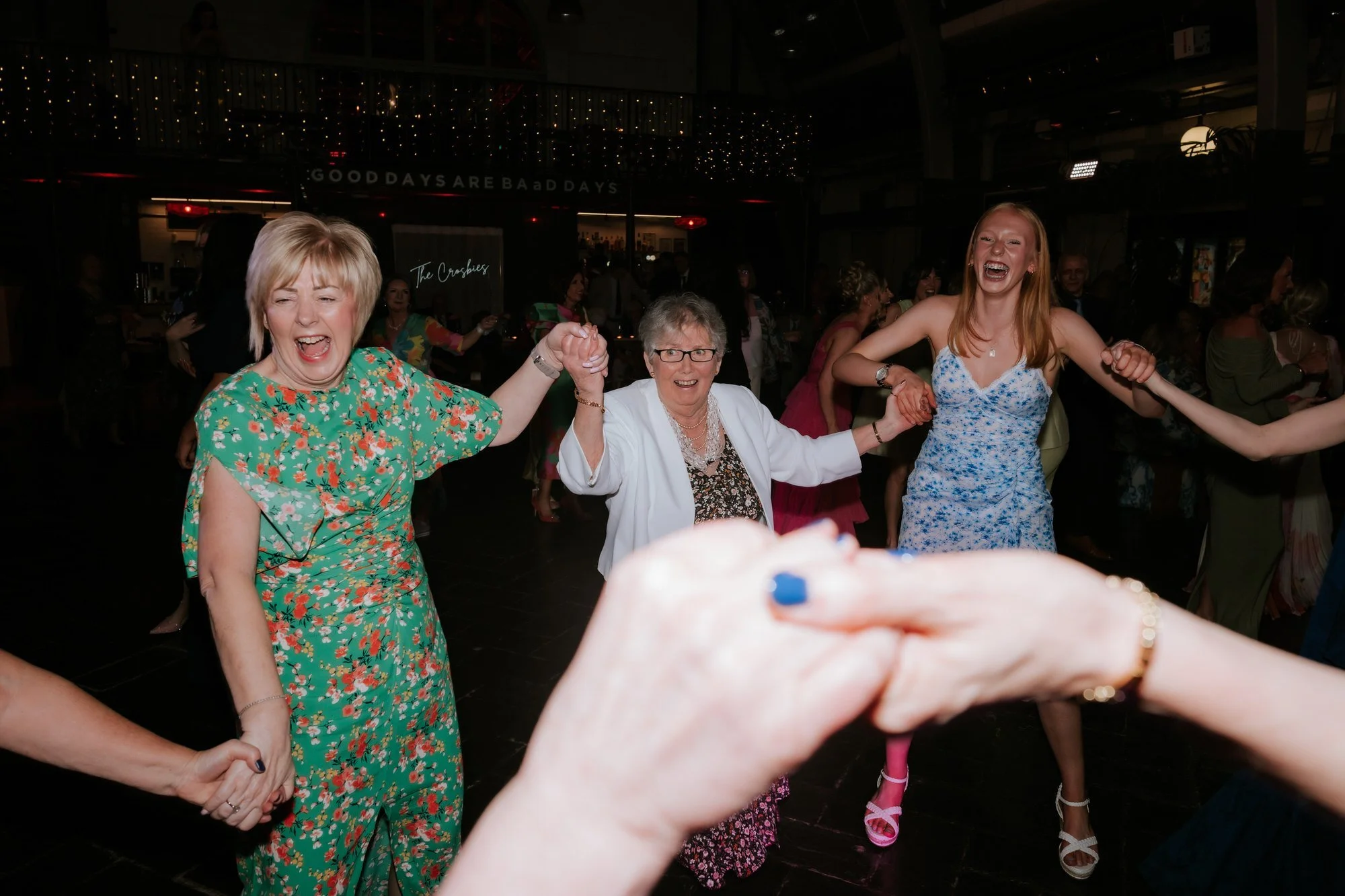 Friends dancing in a circle during the wedding party.