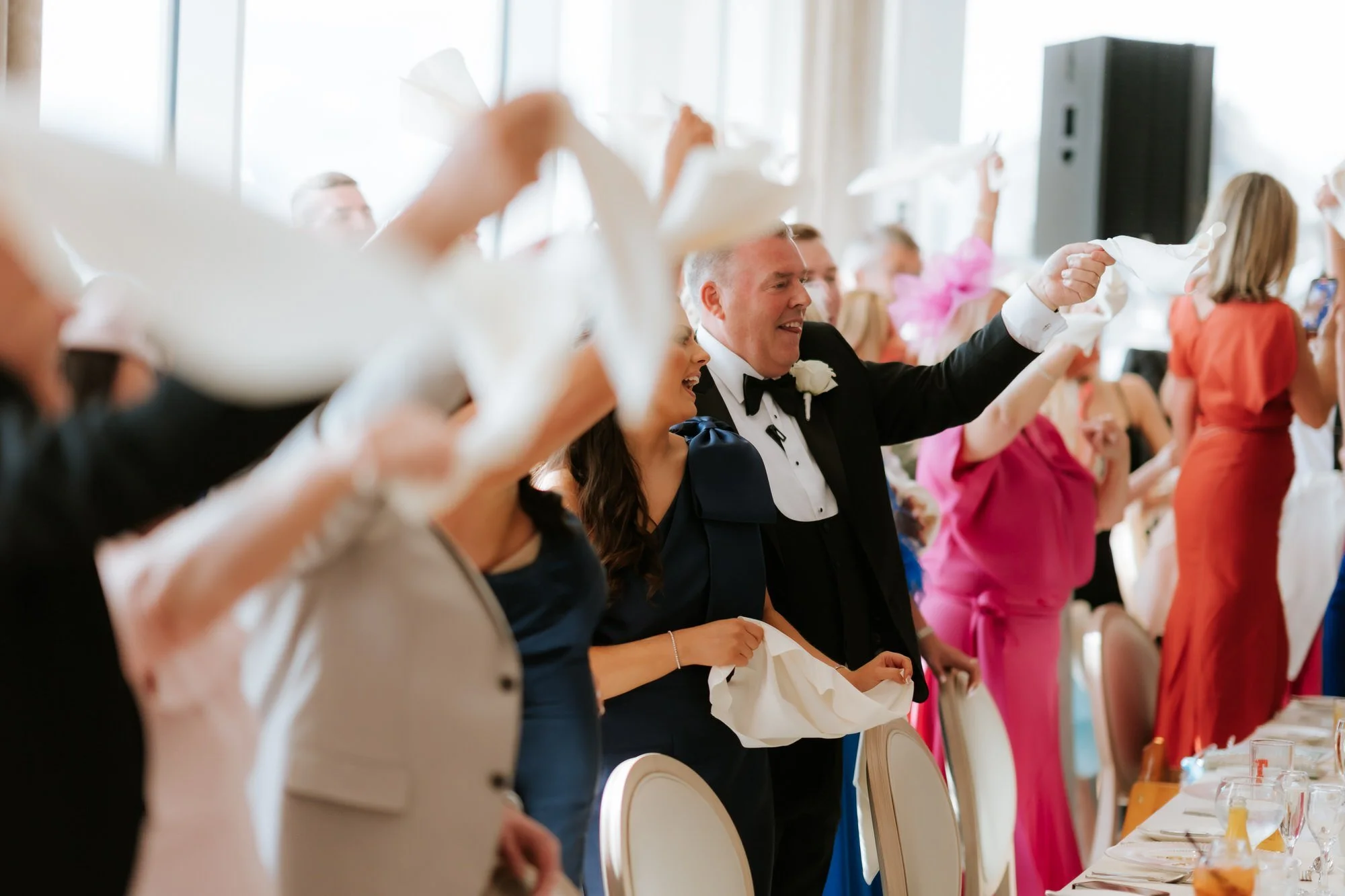 Family members cheering at the wedding breakfast.