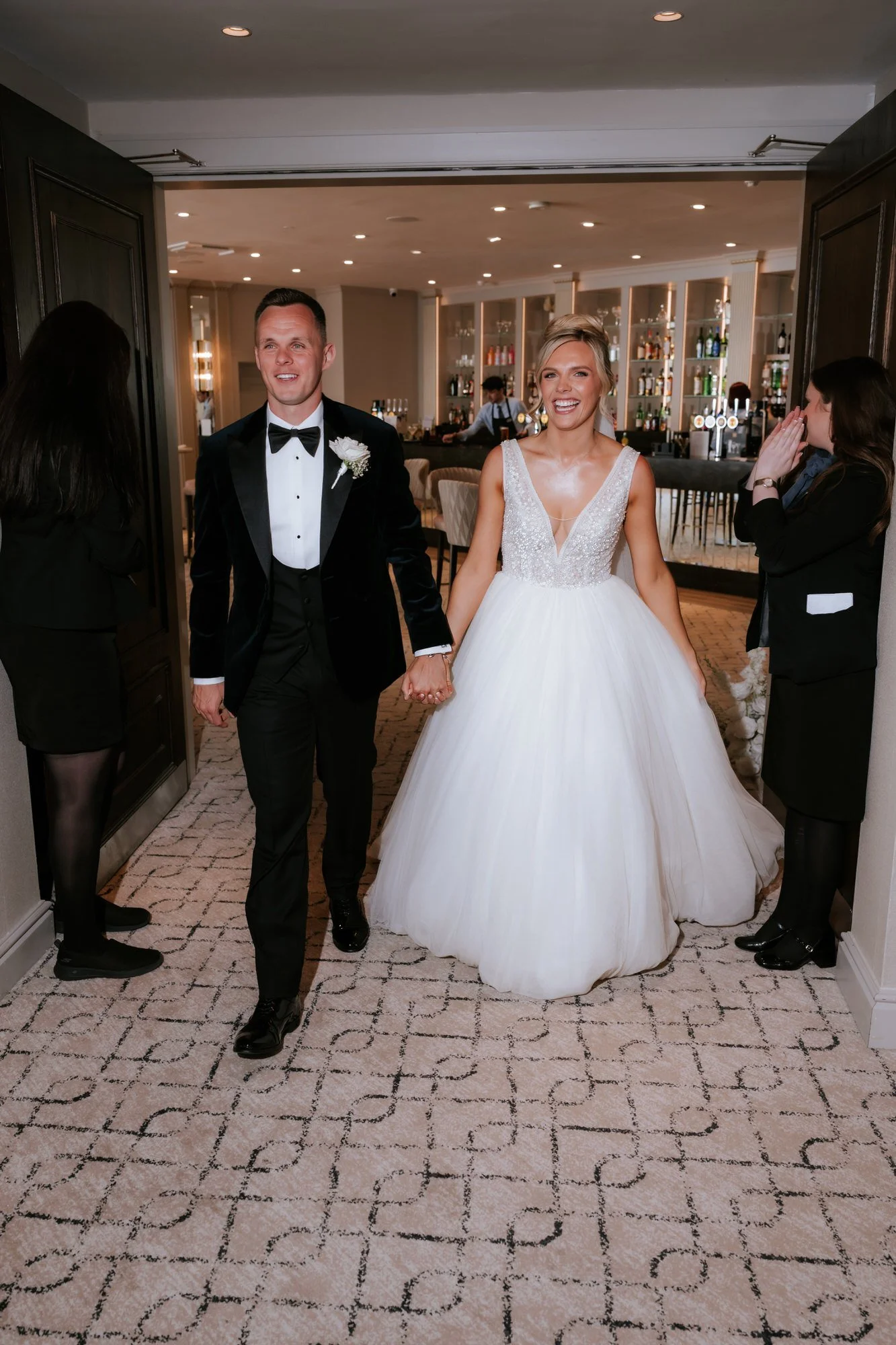 Nicole and Lawrence entering their wedding reception.