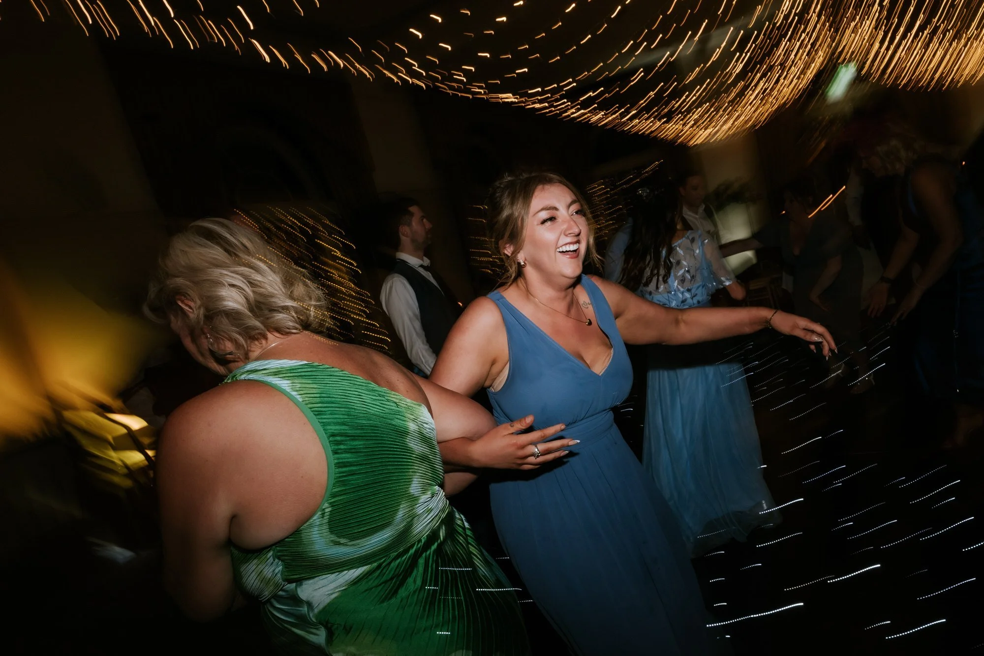 A bridesmaid celebrating on the dance floor.
