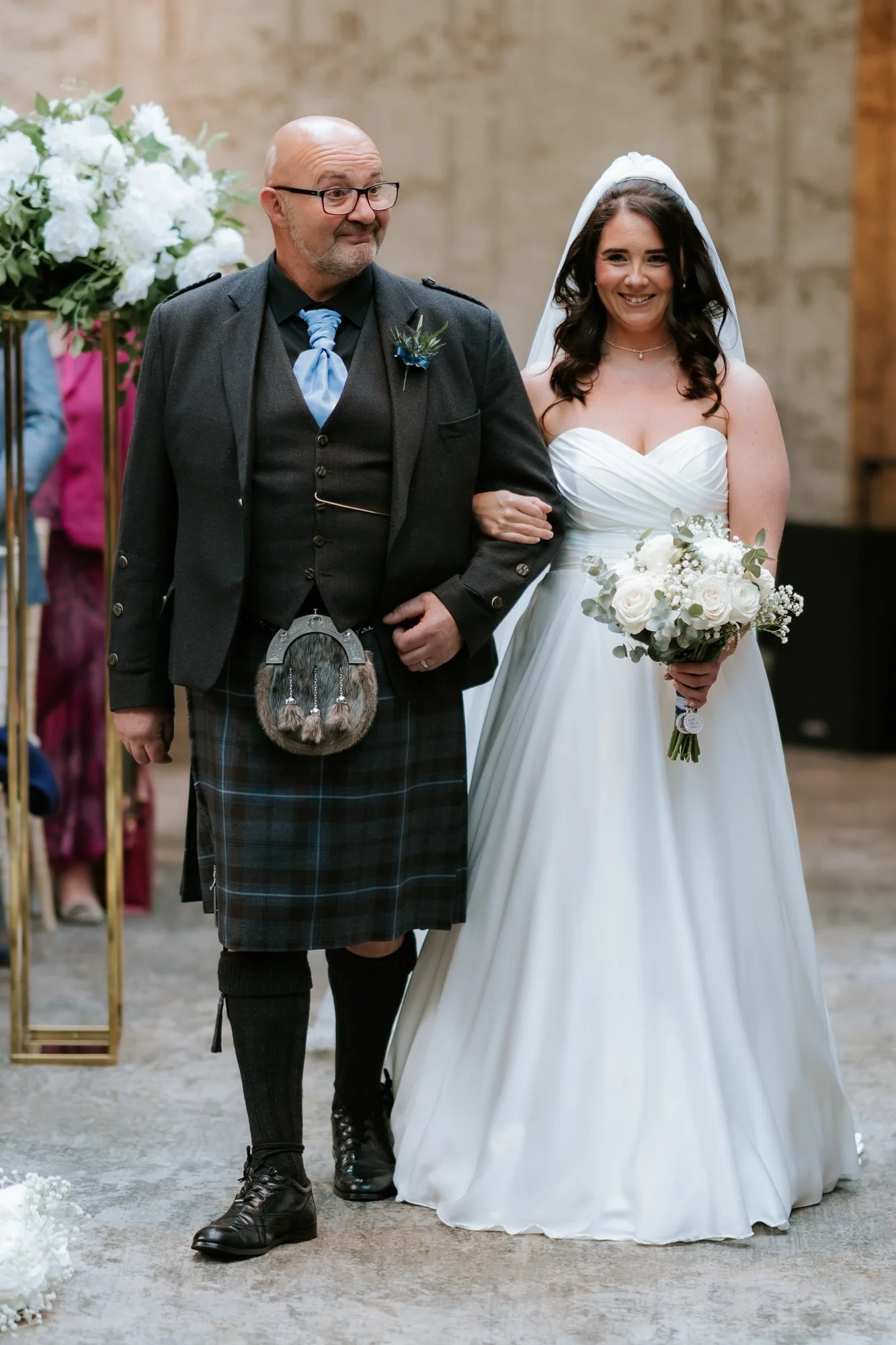 Steph walking down the aisle with her dad.