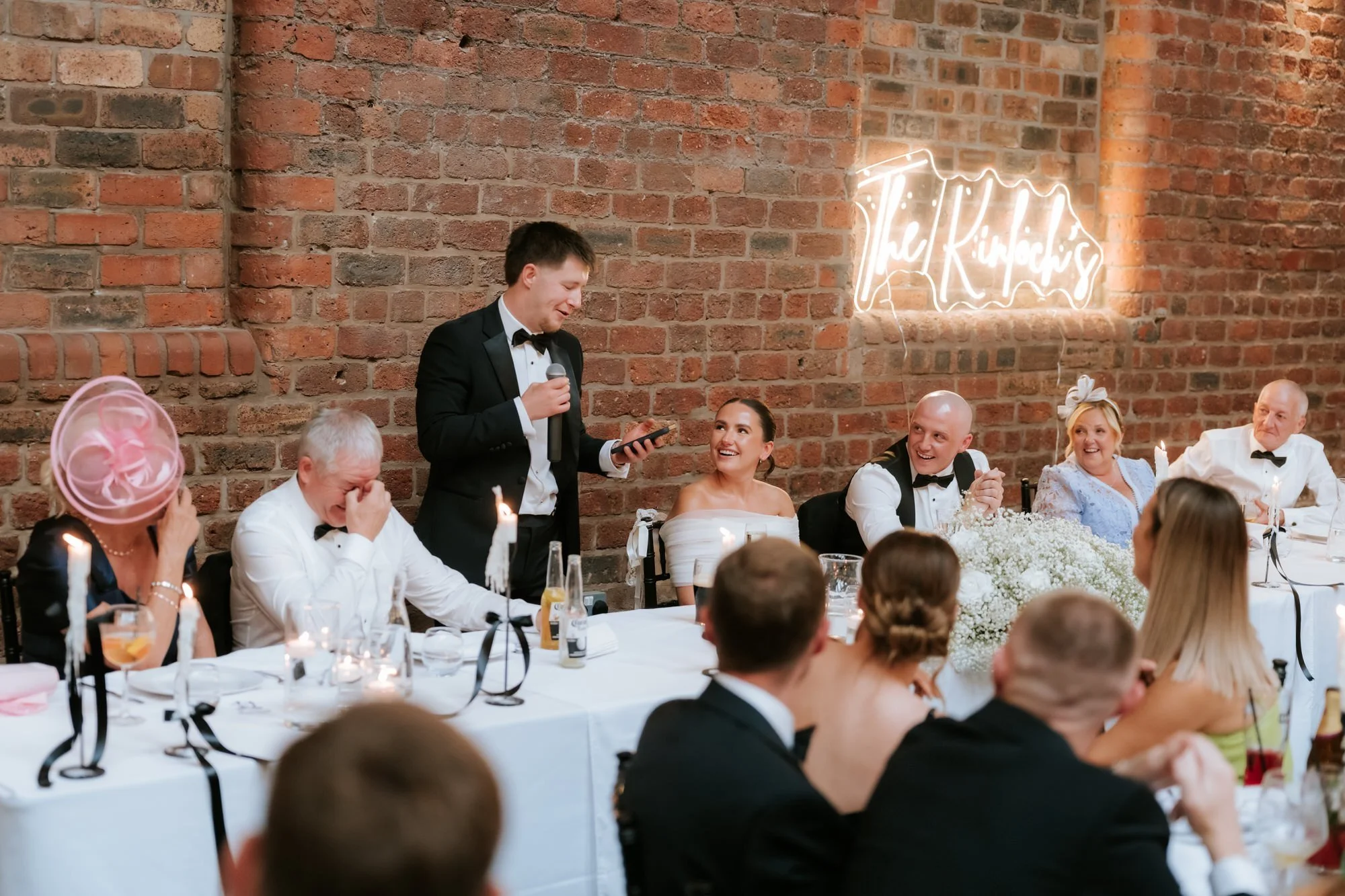 Laughter at the top table during the wedding speeches.