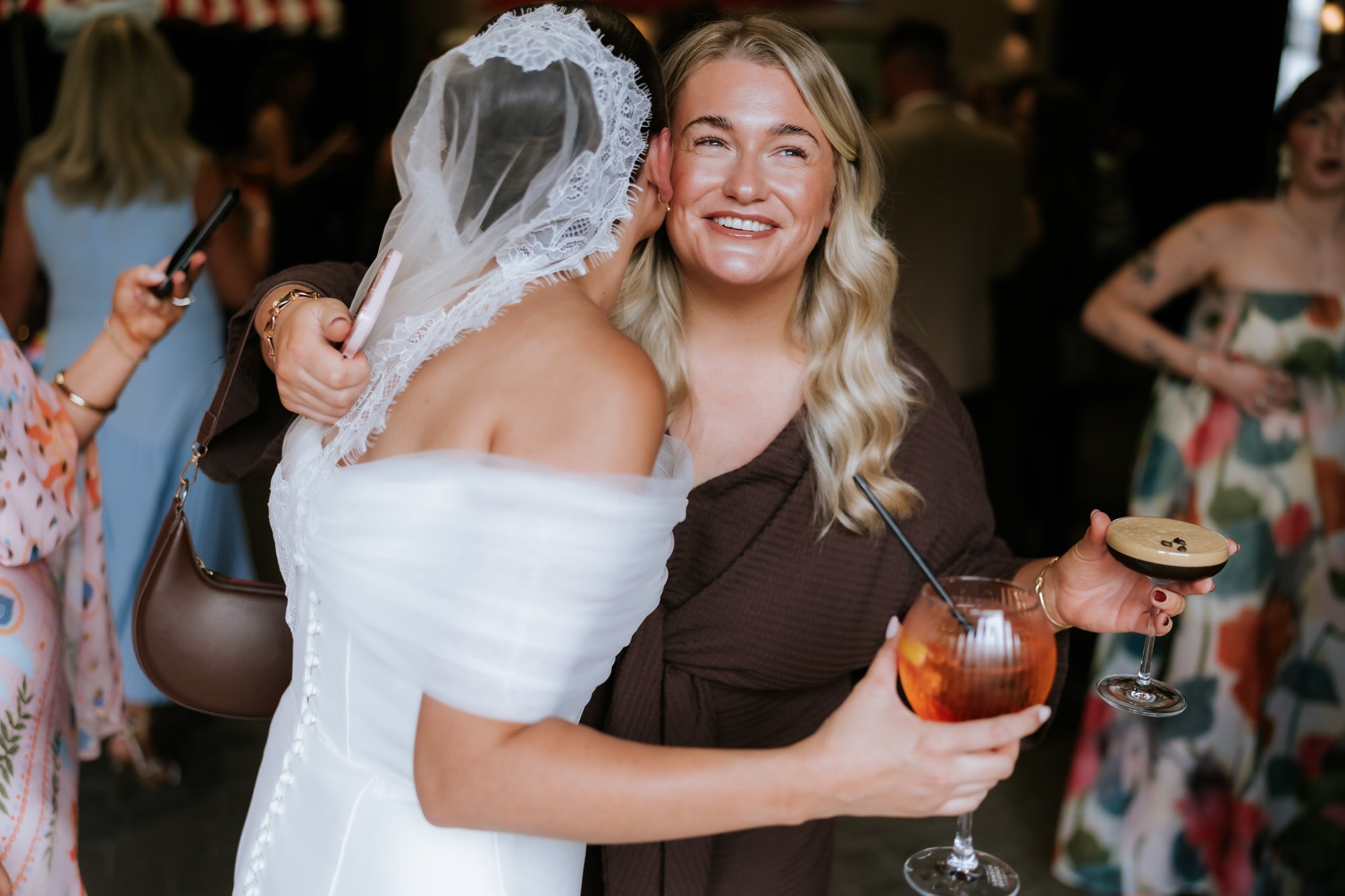 Caitlin greeting a guest with a hug during the drinks reception.