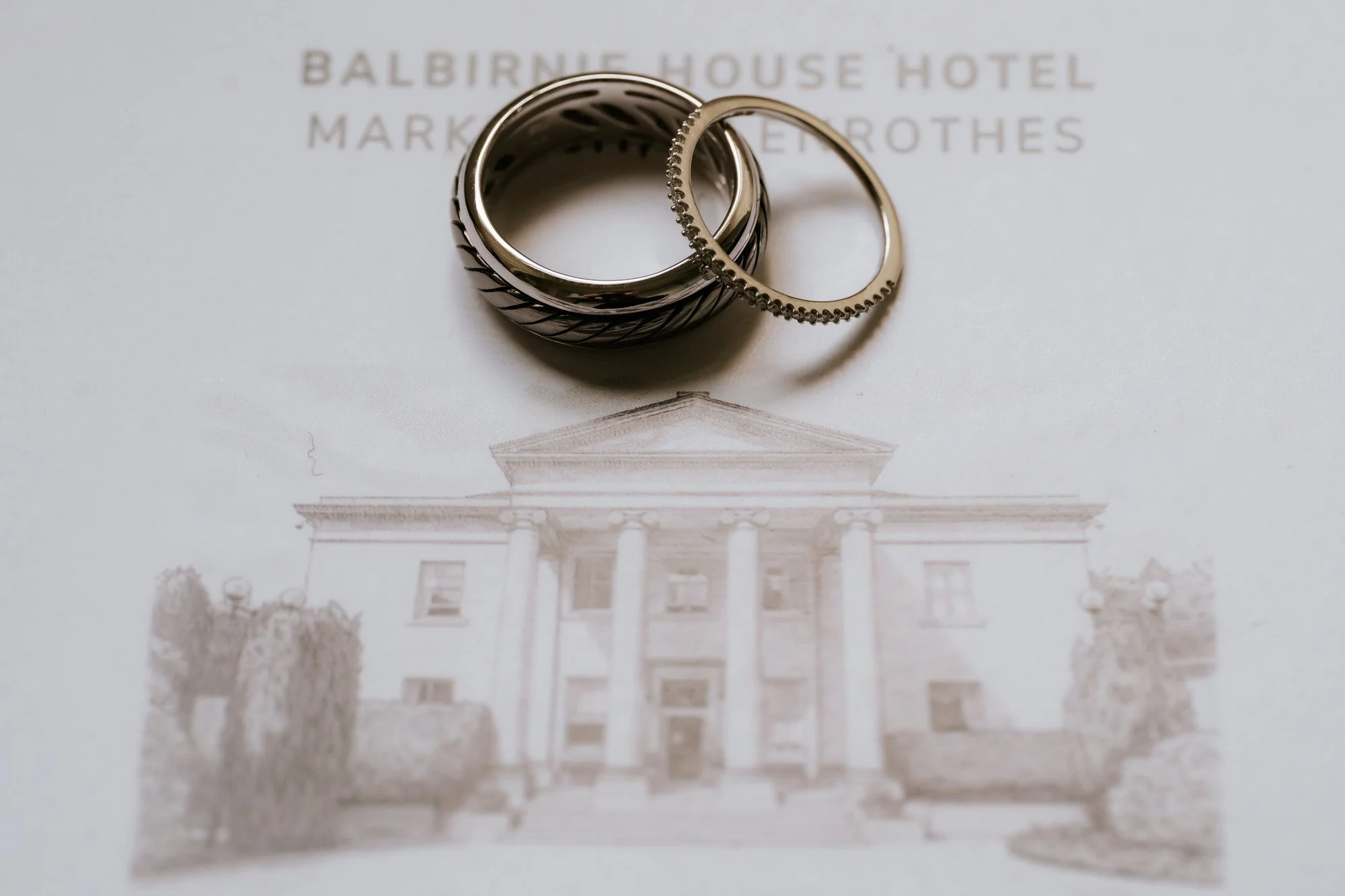 Wedding rings arranged on a Balbirnie House card.
